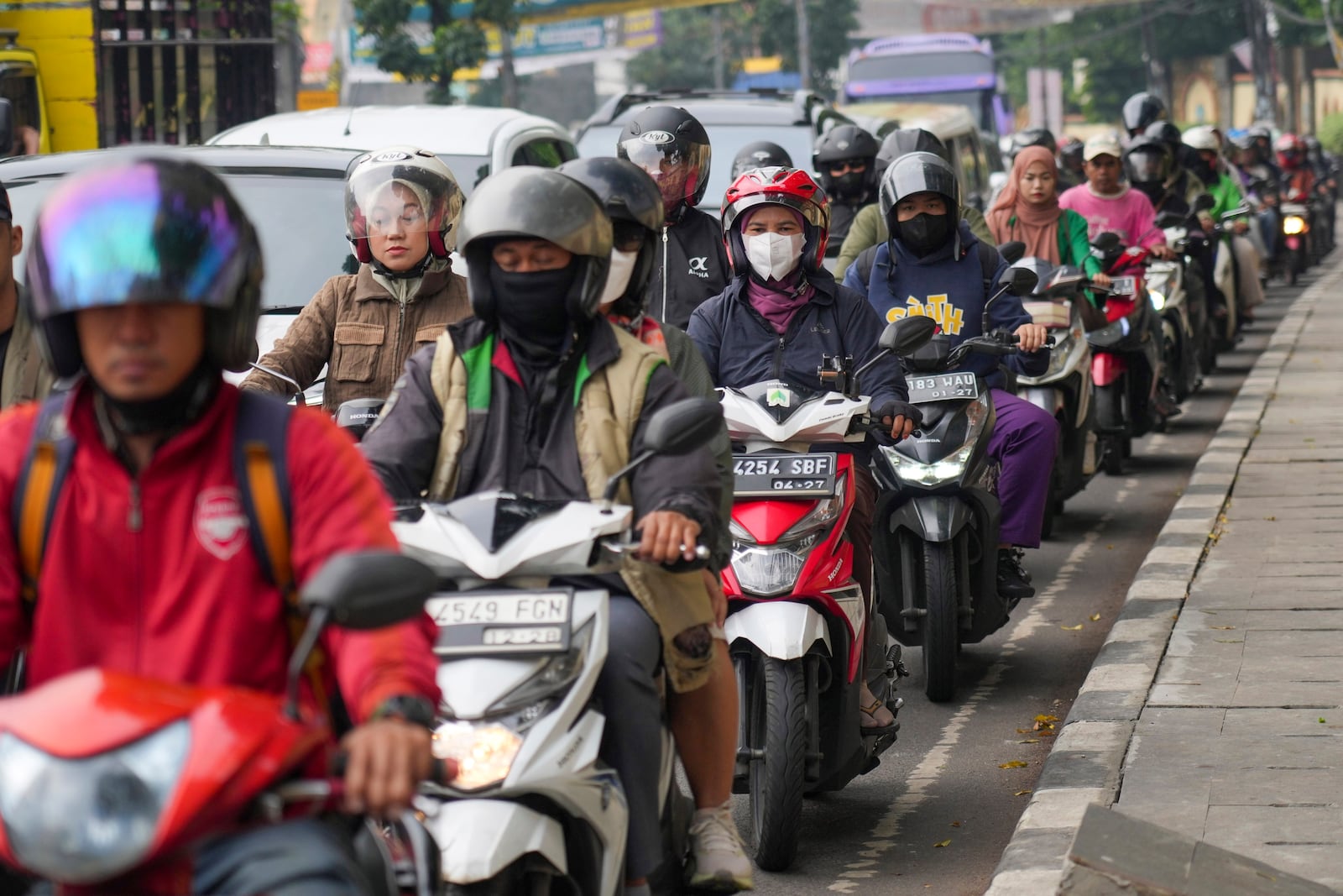 Motorists wait in a traffic jam in Jakarta, Indonesia, on Feb. 11, 2025. (AP Photo/Tatan Syuflana)