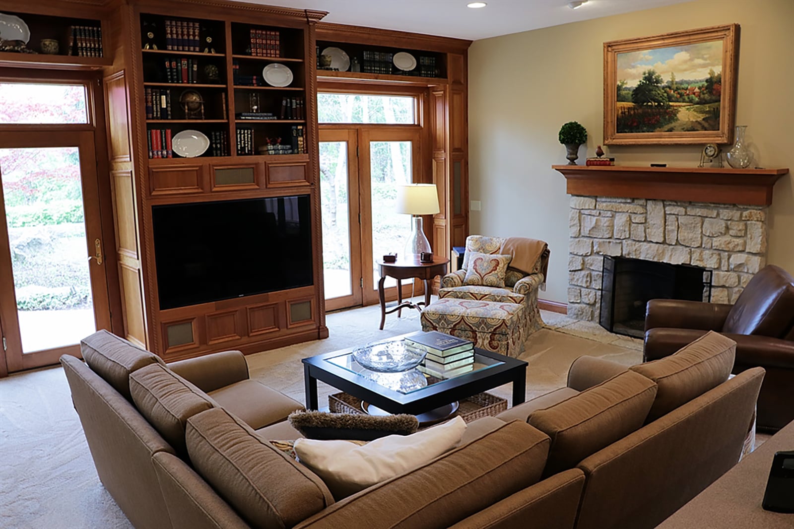 Off the breakfast room is the entrance to a multipurpose great room. The centerpiece to the room is a stone fireplace with a large wood mantle. Built-in bookcases and shelves with wainscoting surround two sets of glass patio doors that open to the backyard sun patio with bridge walkway to the lawn. In between the doors is a built-in media center with hidden speaker. CONTRIBUTED PHOTO BY KATHY TYLER