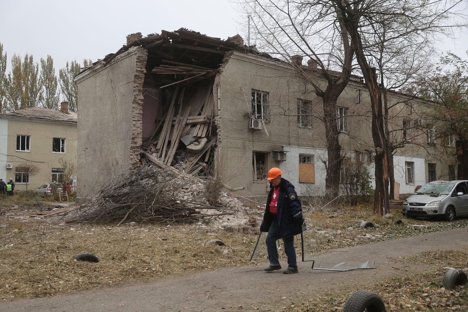 A municipal worker clears the rubble of a residential house damaged by a Russian strike in Zaporizhzhia, Ukraine, Nov. 11, 2024. (AP Photo/Kateryna Klochko)