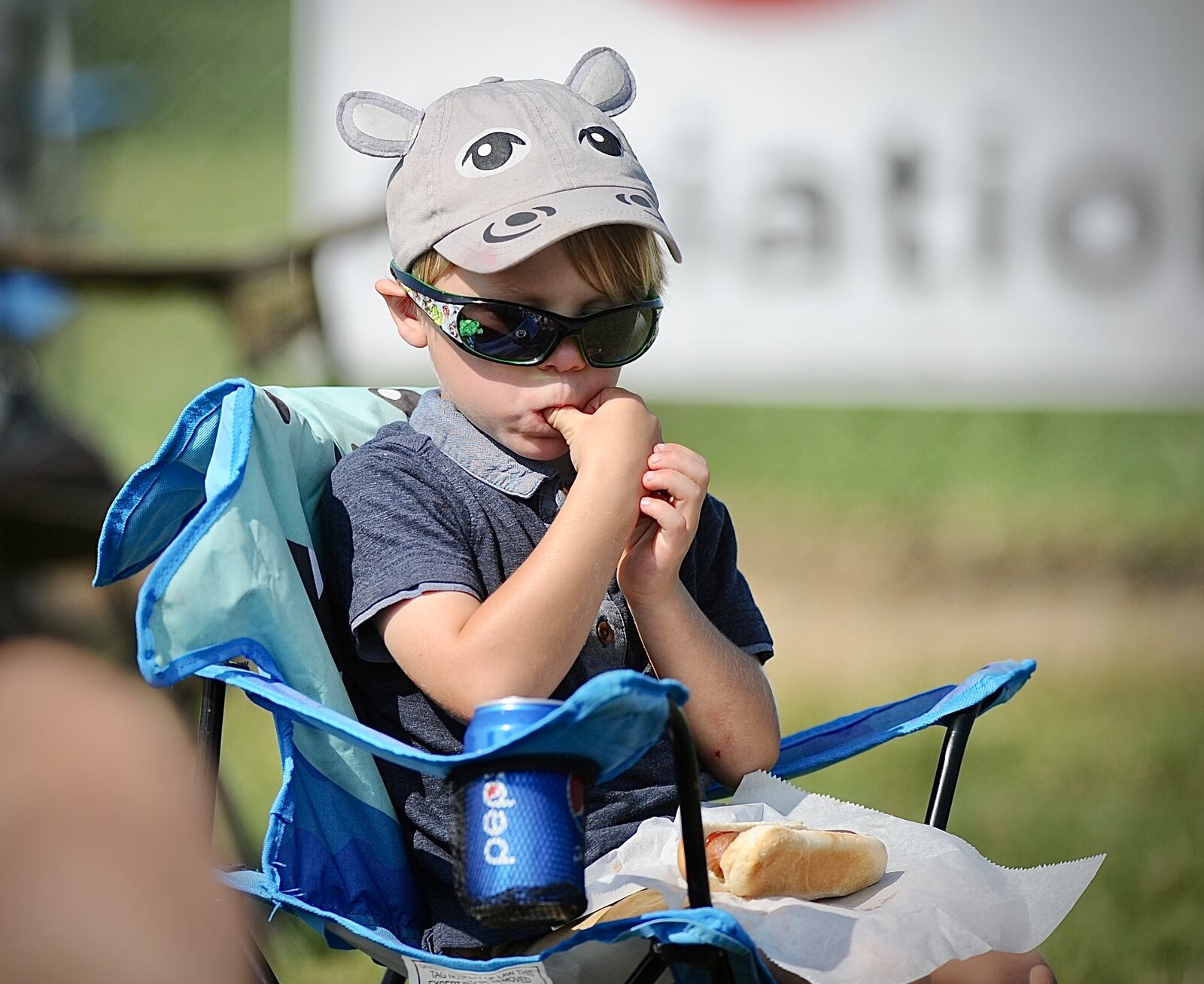 Show goer Bennett Stalling, 4, of Fort Wayne, Ind., is prepared to watch the Dayton Air Show with his hippopotamus hat on Sunday, July 23, 2023. MARSHALL GORBY \STAFF