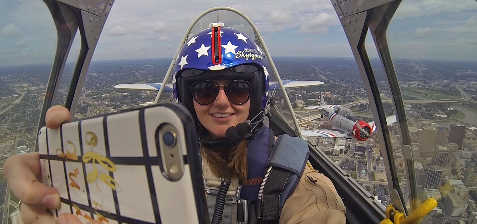 Dayton Daily News business writer Kara Driscoll makes a selphie photo as she files with the GEICO Skytypers on Thursday before the upcoming weekend Vectren Dayton Air Show.