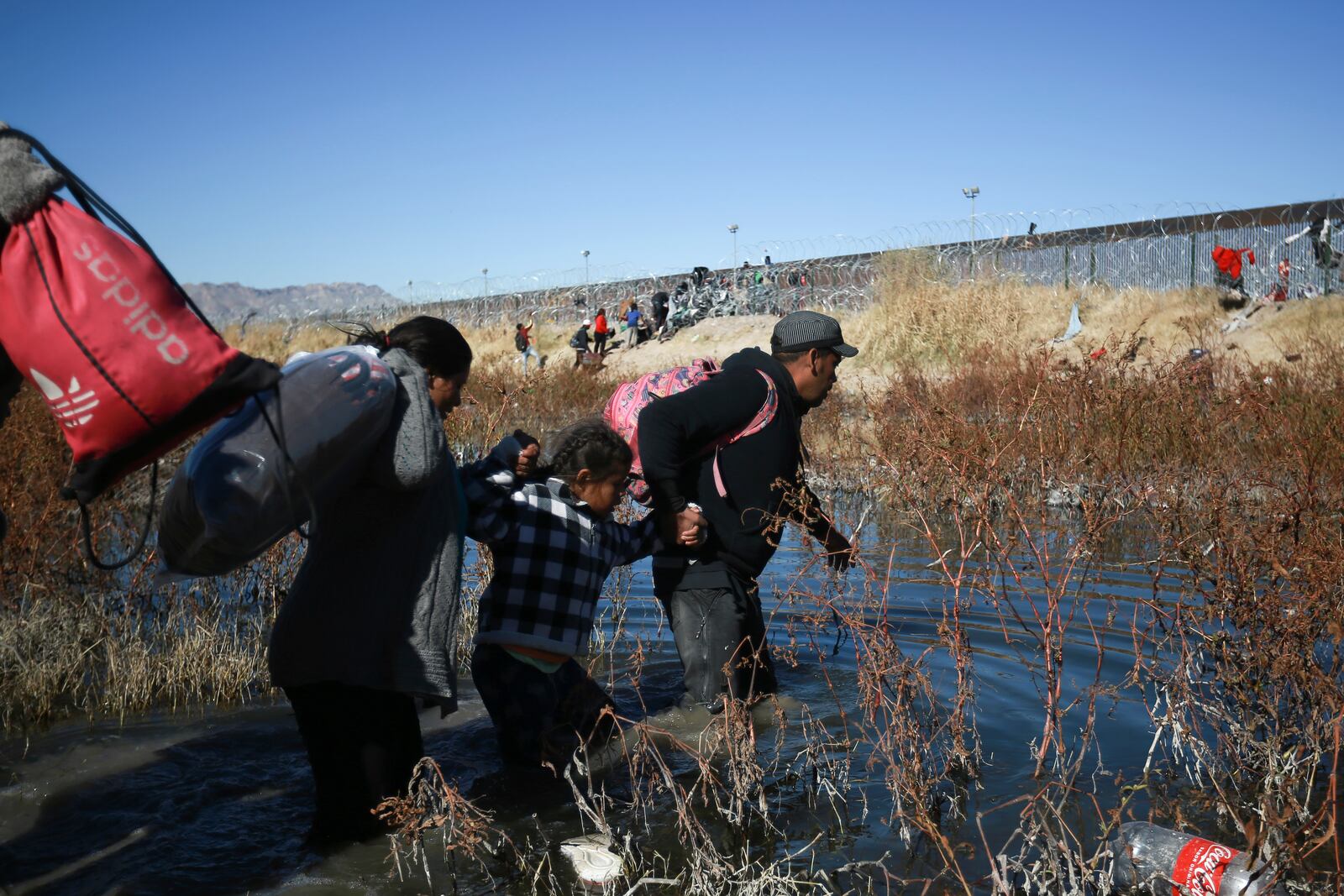 FILE - Migrants cross the Rio Grande to reach the United States from Ciudad Juarez, Mexico, Dec. 27, 2023. (AP Photo/Christian Chavez, File)