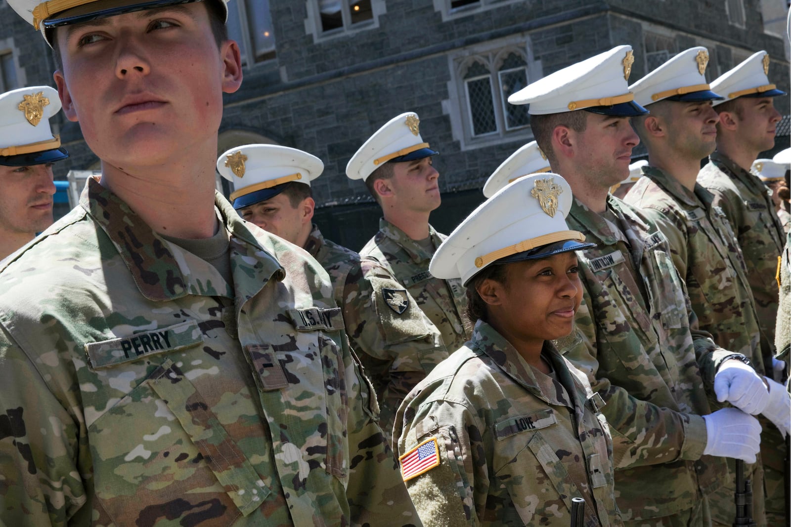 FILE - Briana Love, center, and fellow underclassmen prepare to drill at the U.S. Military Academy, May 22, 2019, at West Point, N.Y. (AP Photo/Mark Lennihan, File)