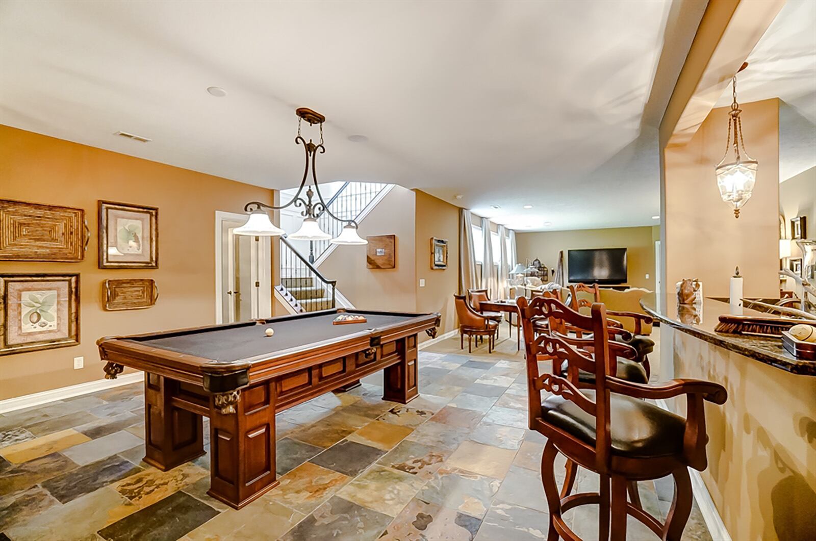 The lower level great room has a wet bar. The two-level peninsula counter has seating for four and a sink on the lower level. A wall counter has additional cabinetry and storage. CONTRIBUTED PHOTO