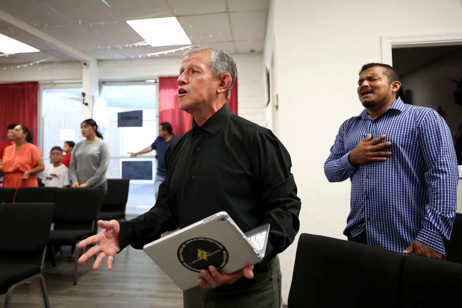 Pastor Arturo Laguna sings during services at Casa de Adoracion, Sunday, Oct. 27, 2024 in Phoenix. (AP Photo/Chris Coduto)