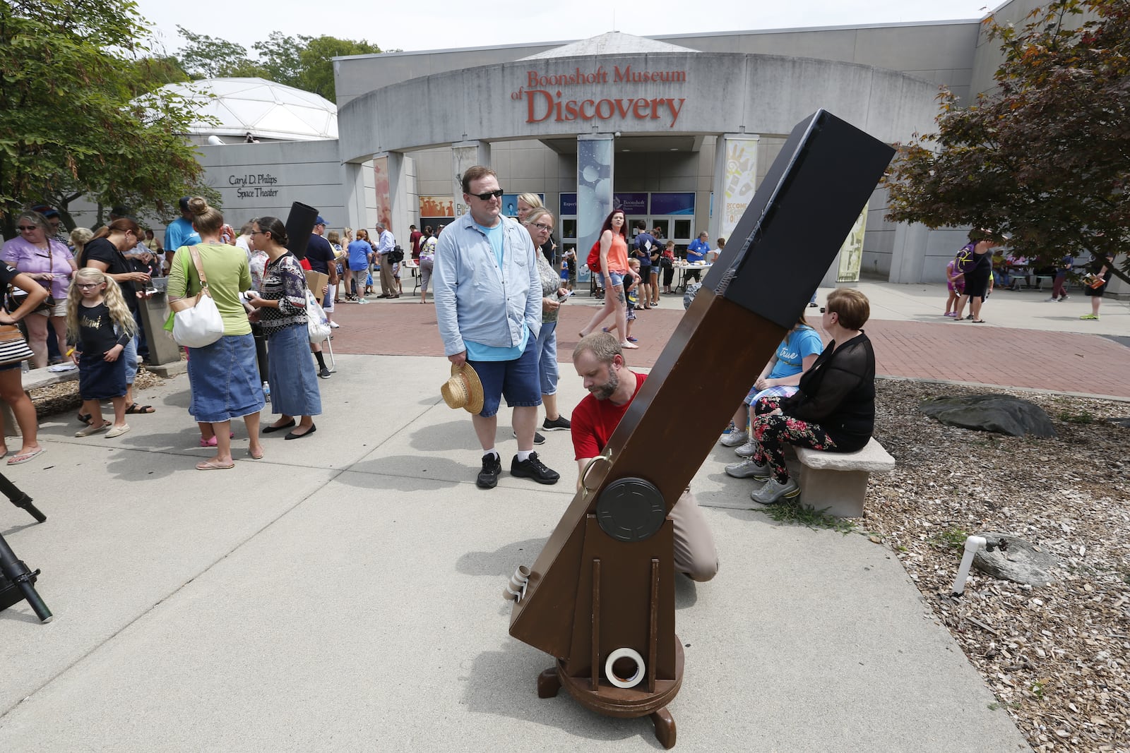 A crowd gathered at the Boonshoft Museum of Discovery to view the solar eclipse on Monday, Aug. 21, 2017. LISA POWELL / STAFF