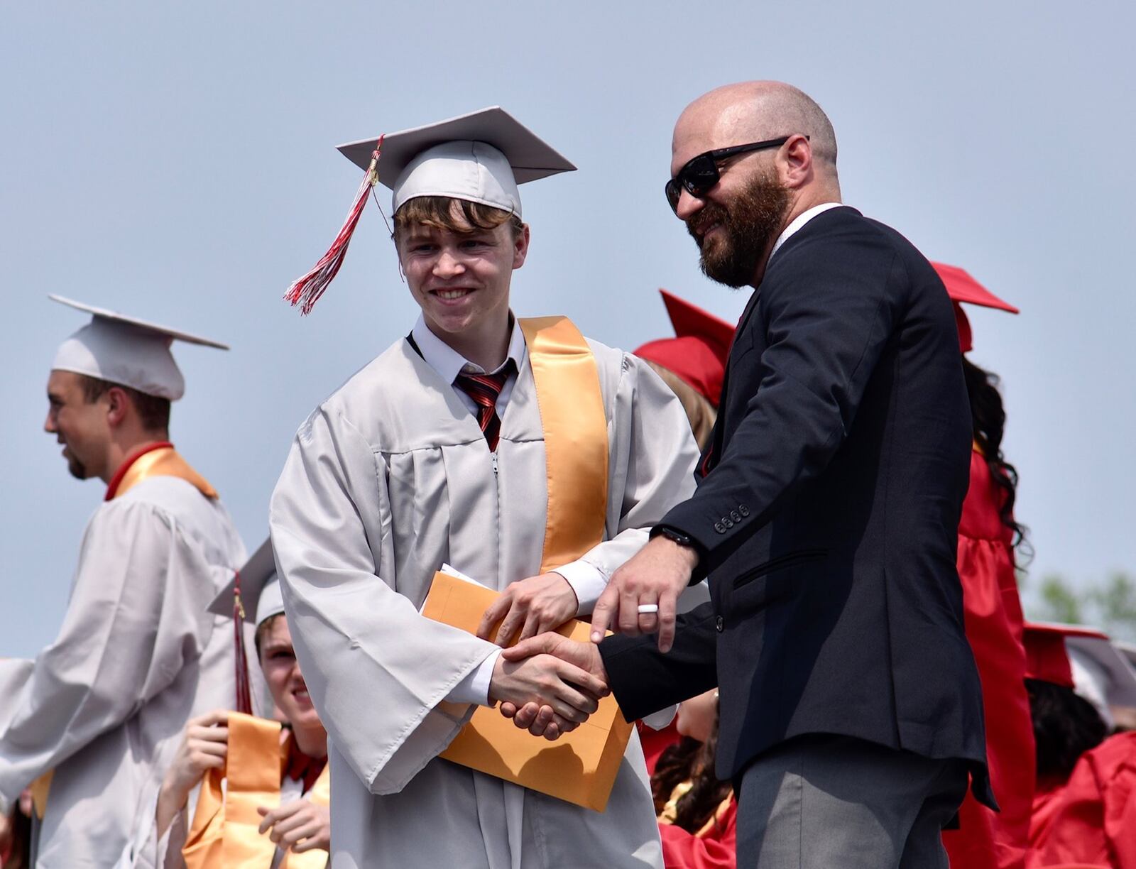 Devin Williams, one of the commencement speakers, shakes hands with Principal Andrew Ewing after getting his diploma during the Northridge High School graduation ceremony Saturday, June 1, 2019. NICK GRAHAM/STAFF