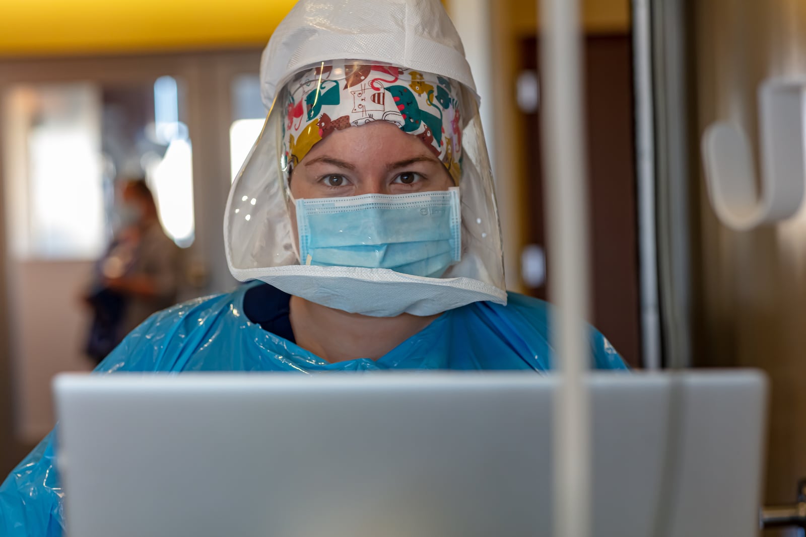 Nurse Taylor Spicer in full PPE gear with an oxygen tank on the back, entering data for a COVID-19 patient, working in Covid unit at Miami Valley Hospital. CONTRIBUTED BY PREMIER HEALTH