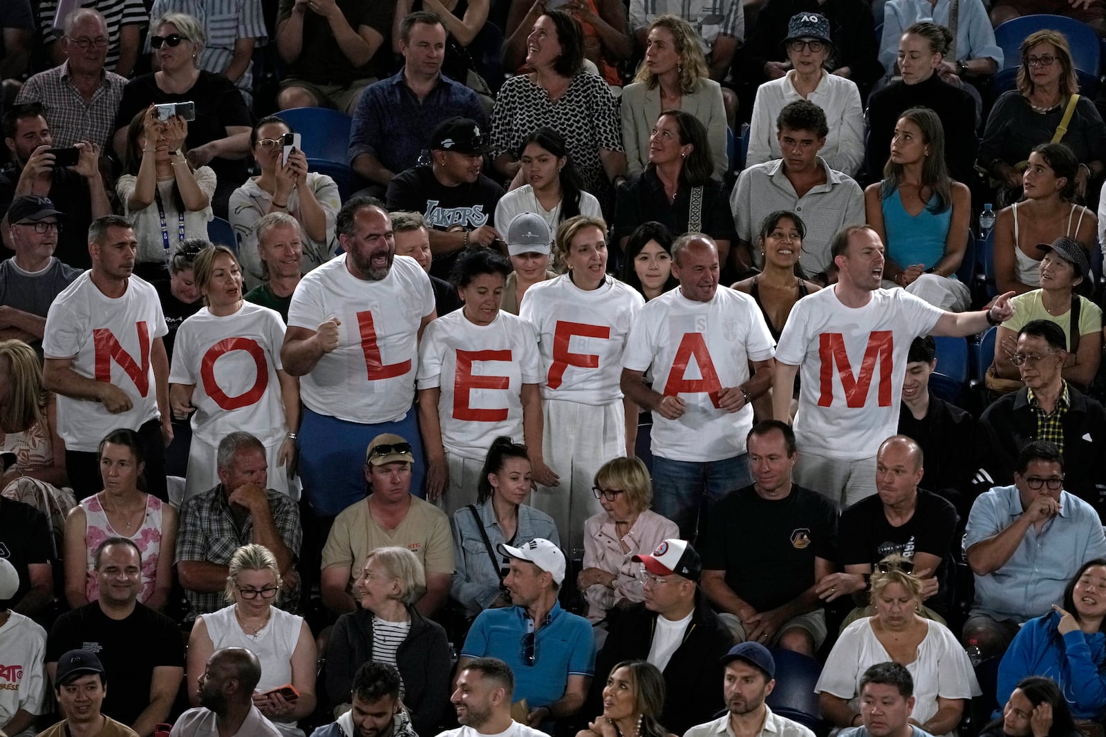 Supporters of Novak Djokovic of Serbia react during his quarterfinal match against Carlos Alcaraz of Spain at the Australian Open tennis championship in Melbourne, Australia, Tuesday, Jan. 21, 2025. (AP Photo/Ng Han Guan)