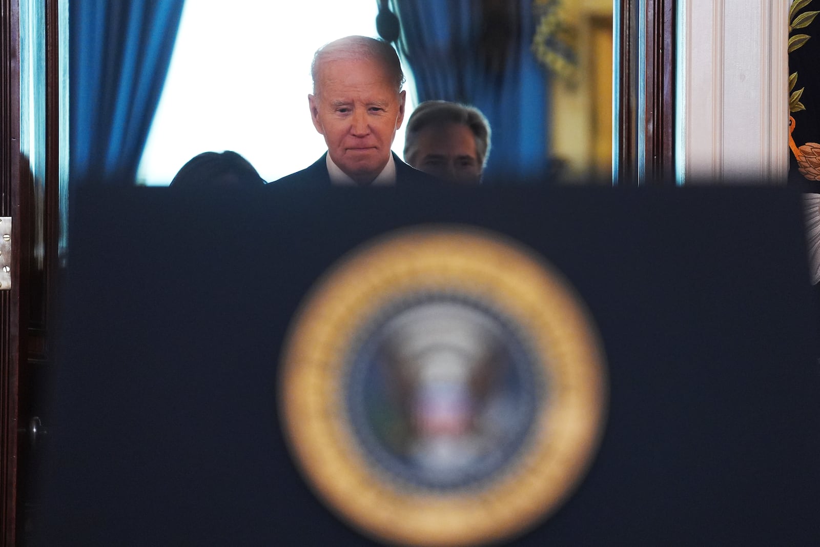 President Joe Biden walking up to the podium to speak in the Cross Hall of the White House on the announcement of a ceasefire deal in Gaza and the release of dozens of hostages after more than 15 months of war, Wednesday, Jan. 15, 2025, in Washington. (AP Photo/Evan Vucci)