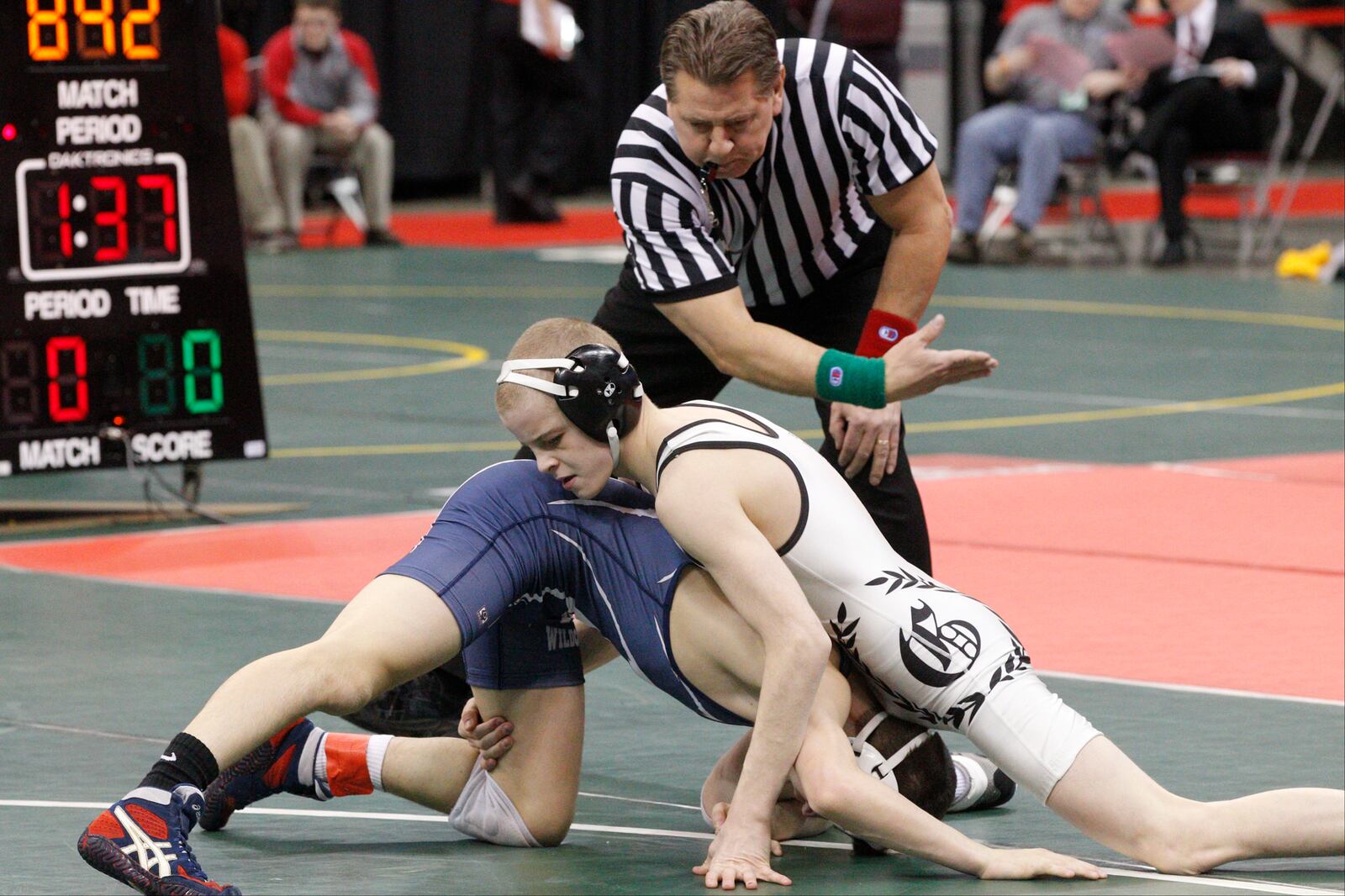 Eli Stickley of St. Paris Graham wrestles Seth Beard of Napoleon at 106 pounds during the semi-final round of the Ohio high school wrestling championships at the Jerome Schottenstein Center in Columbus on March 1, 2013. Staff File