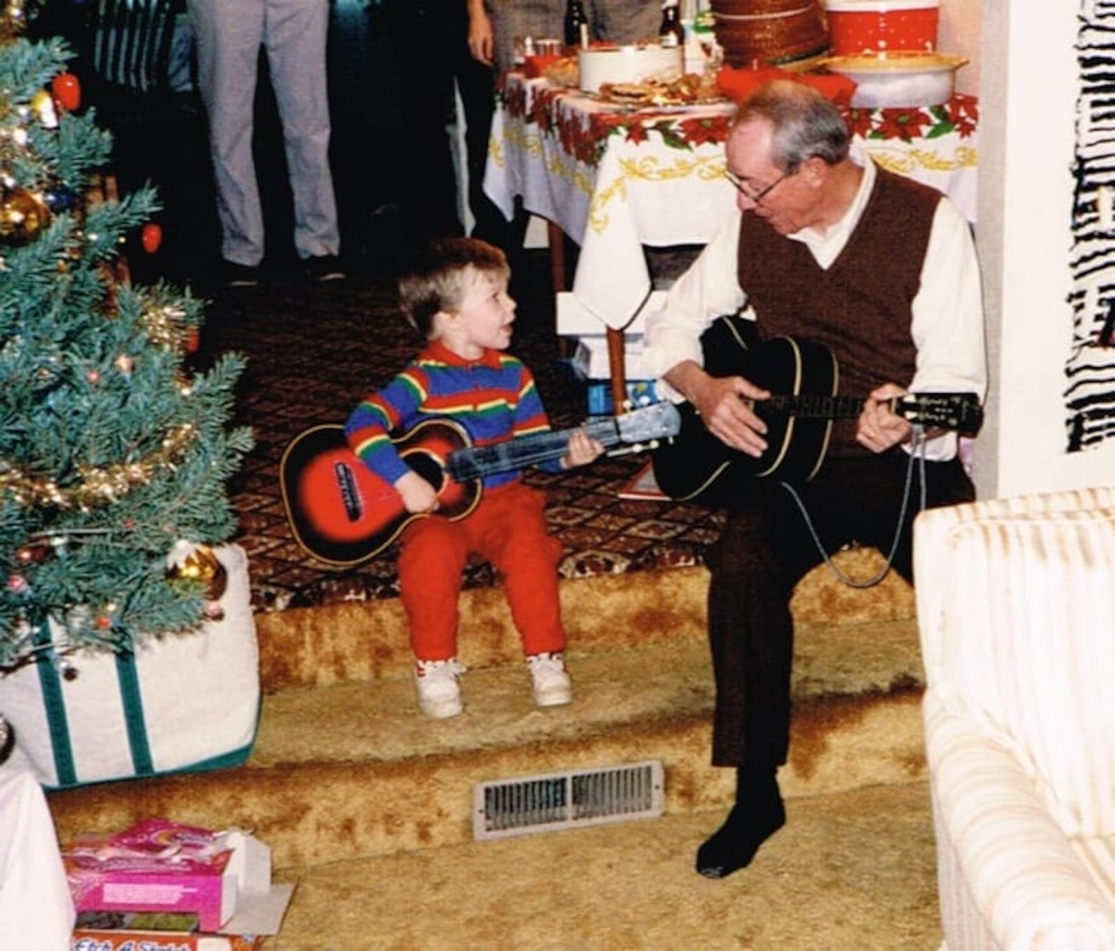 Richard Campbell’s father plays guitar with Campbell’s son, Chris. Campbell comes from a musical family, and he finds songs to be a good escape from the news cycle. Photo provided by Richard Campbell