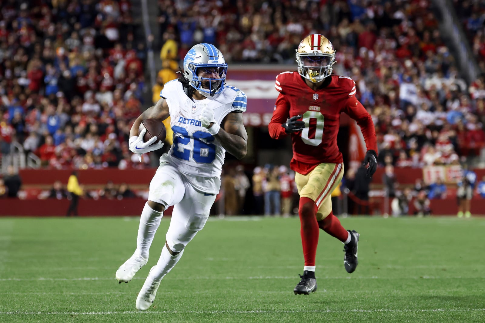 Detroit Lions running back Jahmyr Gibbs (26) scores a rushing touchdown past San Francisco 49ers cornerback Renardo Green (0) during the second half of an NFL football game Monday, Dec. 30, 2024, in Santa Clara, Calif. (AP Photo/Jed Jacobsohn)