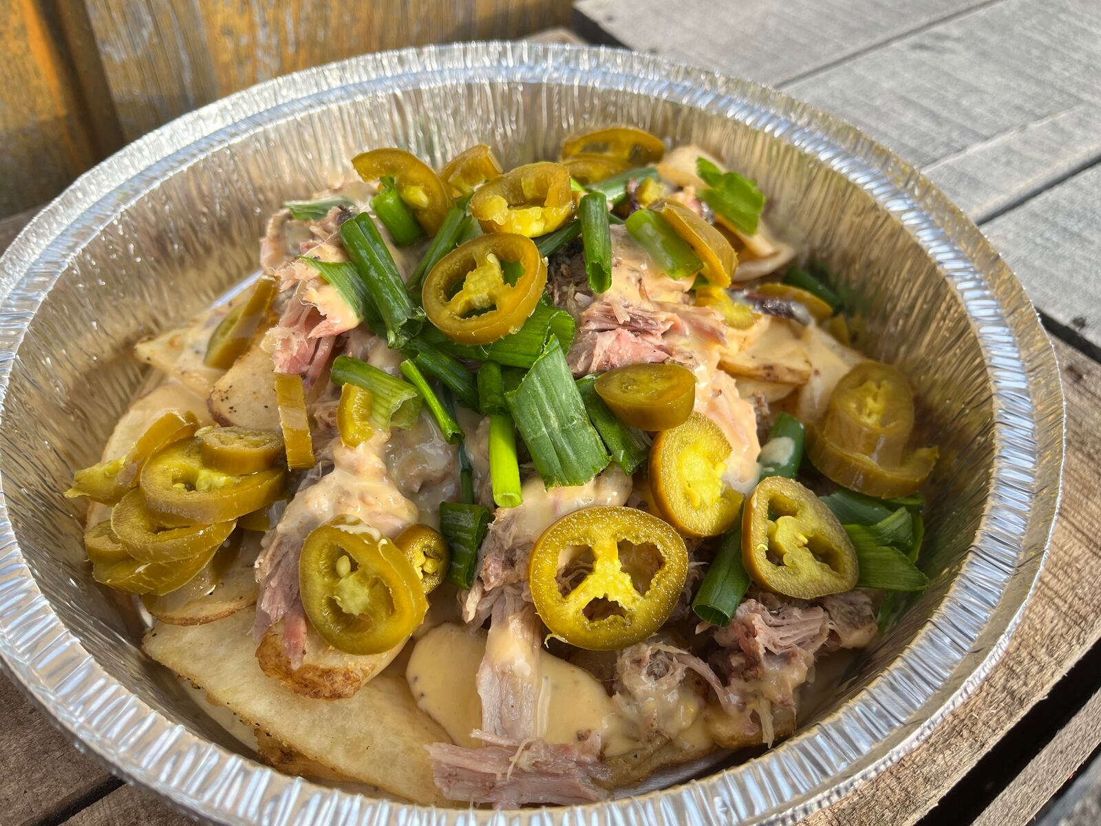 Pictured are the Gut Buster Loaded Fries from HVO’s Coop Snack Shack. The thinly-sliced steak fries were loaded with BBQ pulled pork, beer cheese, green onion and jalapenos. NATALIE JONES/STAFF