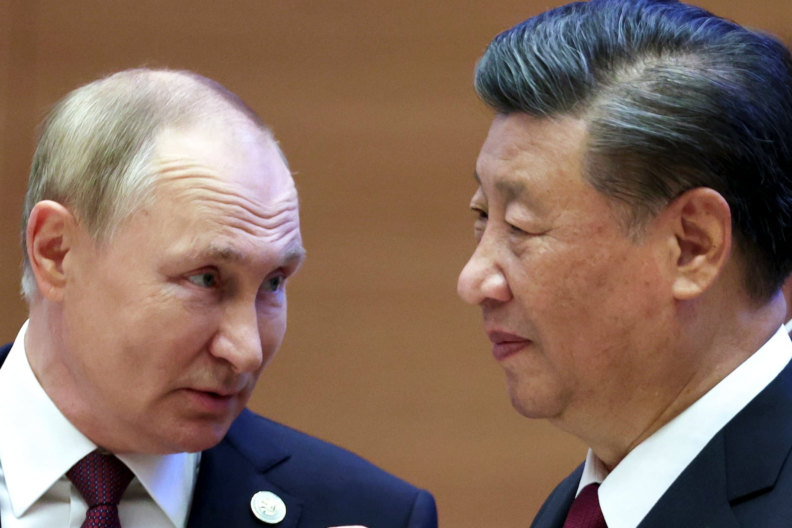 FILE - Russian President Vladimir Putin, left, speaks to Chinese President Xi Jinping at the Shanghai Cooperation Organization summit in Samarkand, Uzbekistan, on Sept. 16, 2022. (Sergei Bobylev, Sputnik, Kremlin Pool Photo via AP, File)