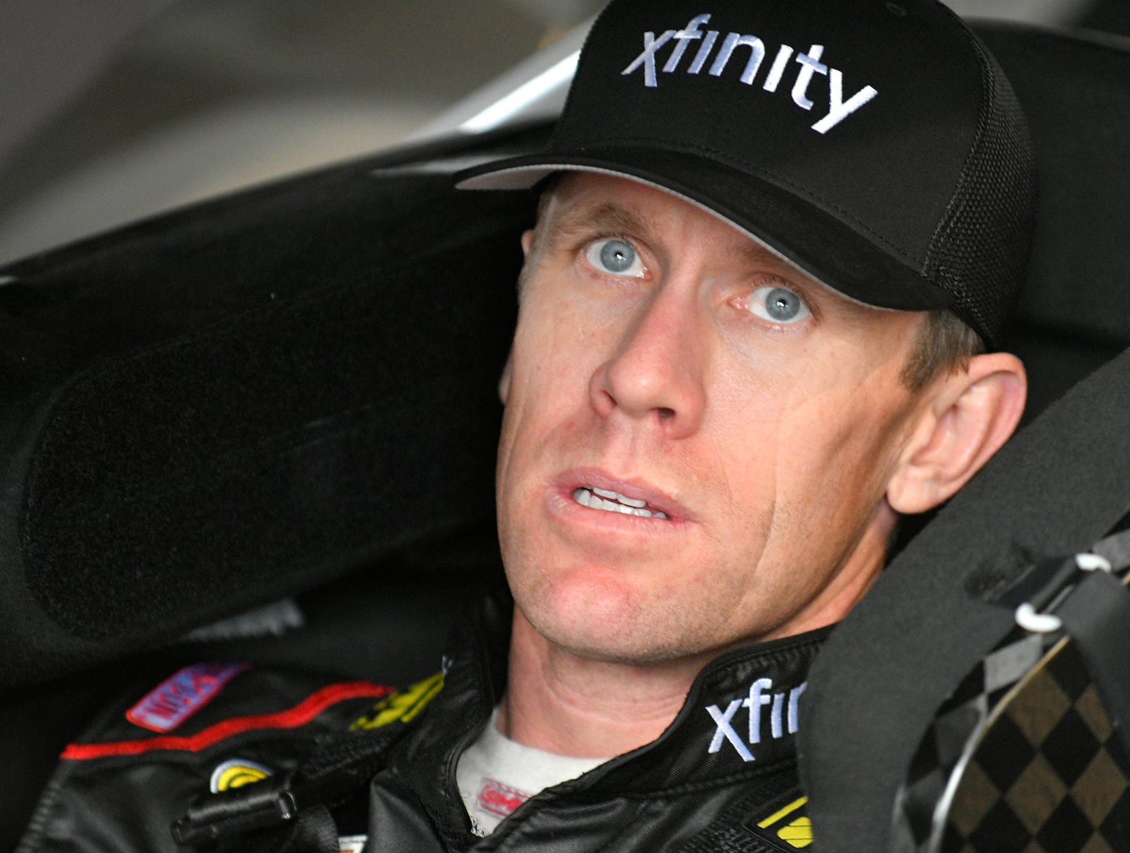 FILE - Carl Edwards sits in the garage during practice for the NASCAR Cup Series auto race at Kansas Speedway in Kansas City, Kan., Oct. 15, 2016. (AP Photo/Ed Zurga, File)