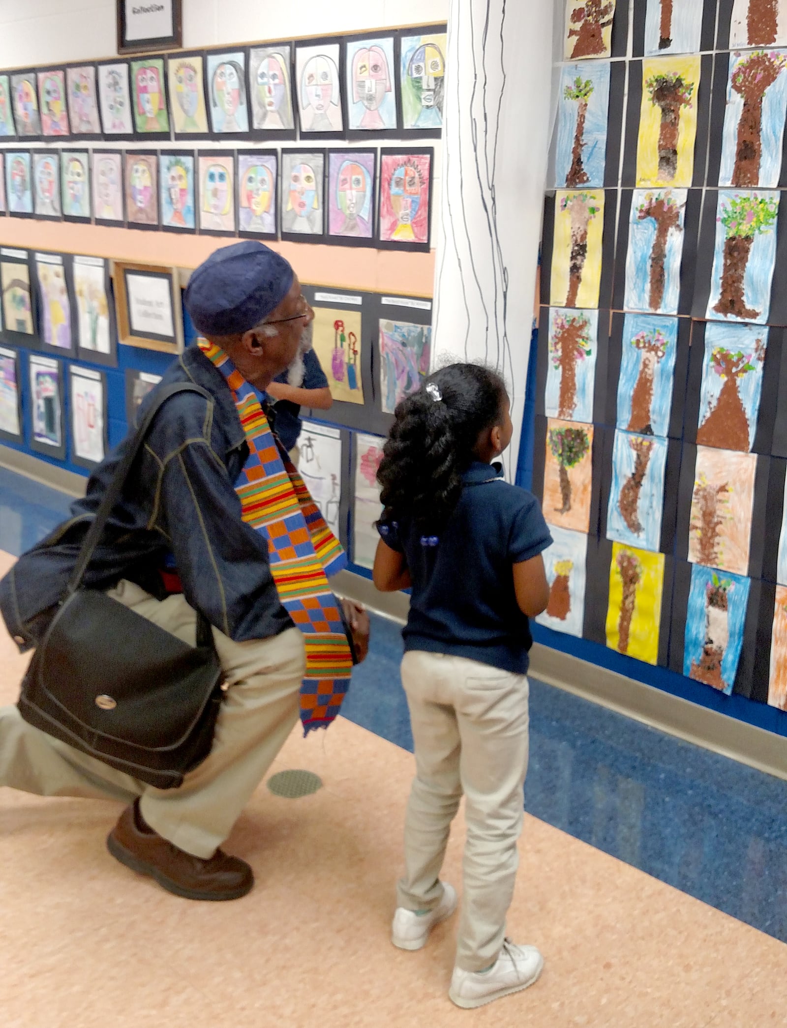 “Docent” Kmauri Walker of Louise Troy elementary school explains the Seurat collection to artist Bing Davis. CONTRIBUTED