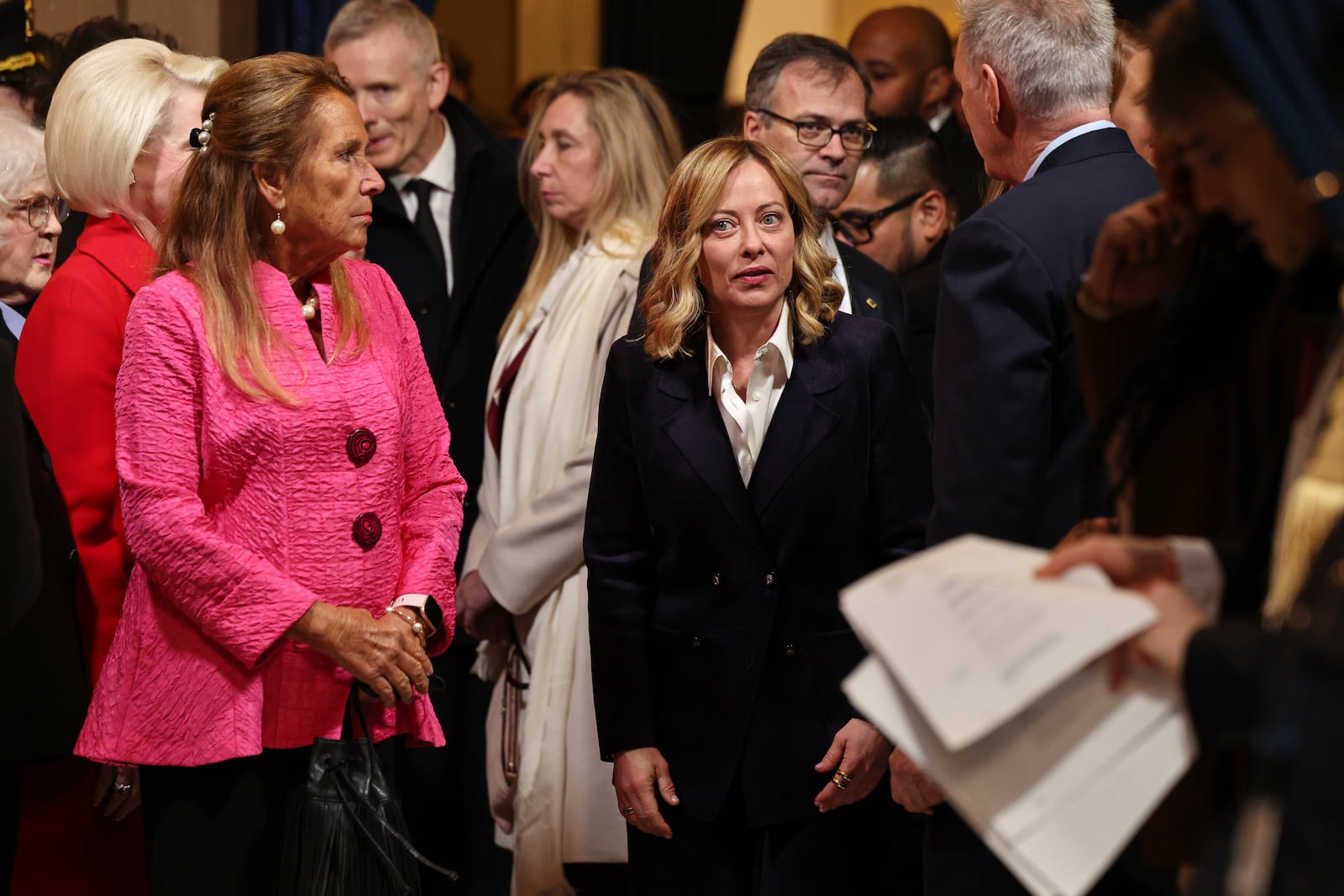 Italian Premier Giorgia Meloni, center, arrives before the 60th Presidential Inauguration in the Rotunda of the U.S. Capitol in Washington, Monday, Jan. 20, 2025. (Chip Somodevilla/Pool Photo via AP)