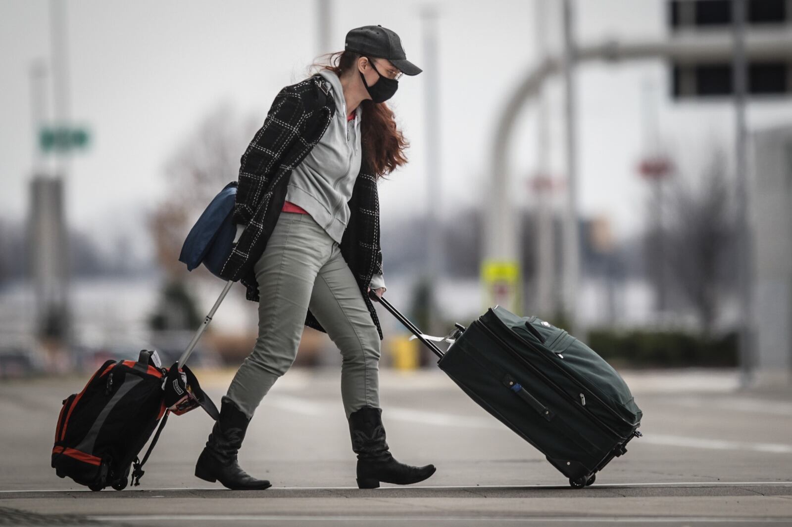 A traveler leaves the Dayton airport Monday Dec. 7, 2020. .