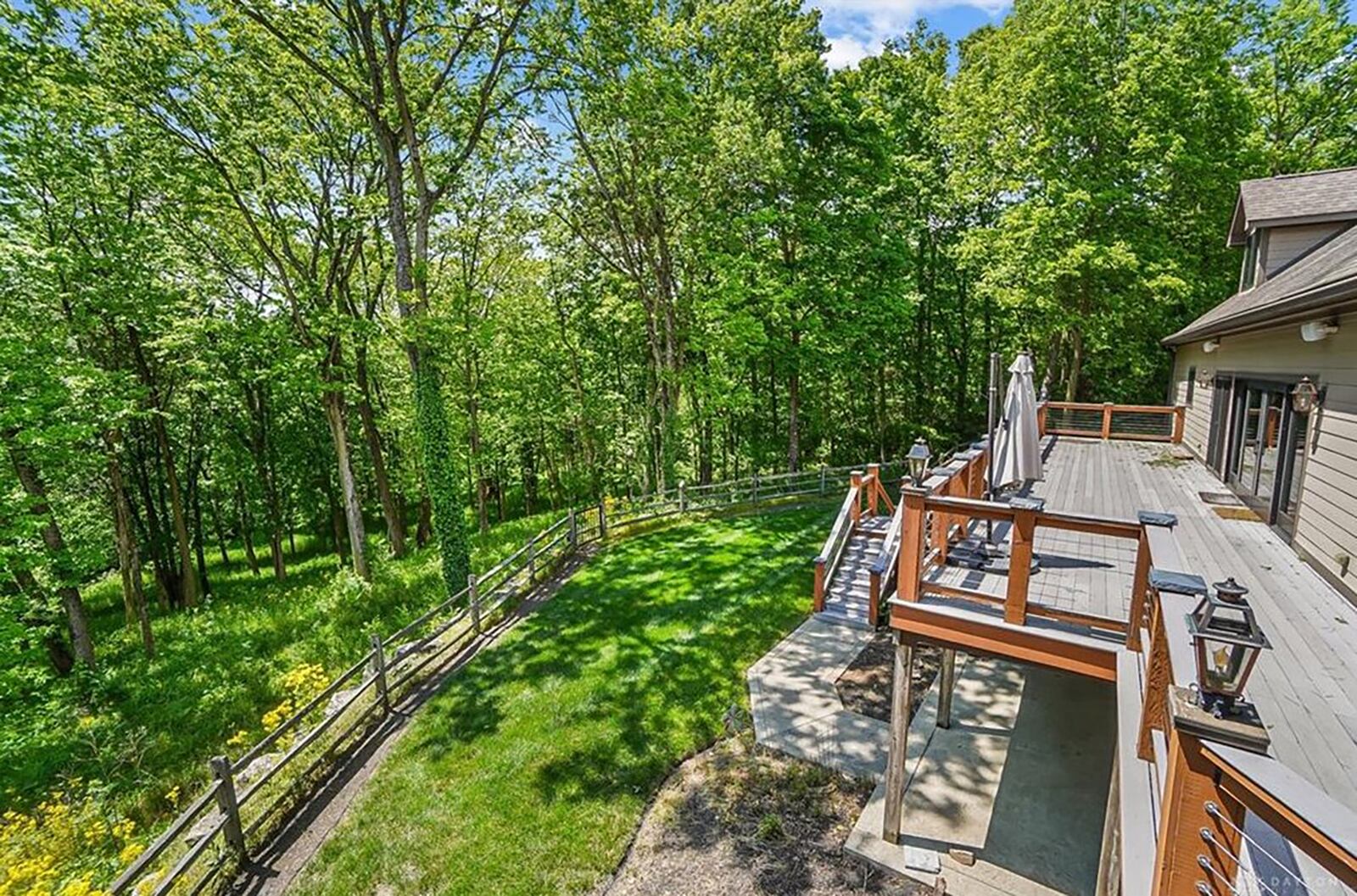 The rear of the home is partially fenced and overlooks the heavily wooded lot. There is a path leading to the Stillwater River.