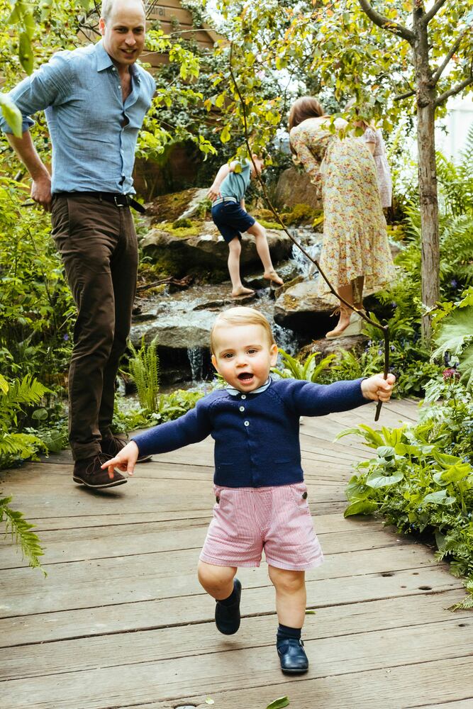 In this image made available on Sunday May 19, 2019 by Kensington Palace, Britain's Kate, Duchess of Cambridge and her son Prince Louis play in the ‘Bback to Nature’ garden at the RHS Chelsea Flower Show in London