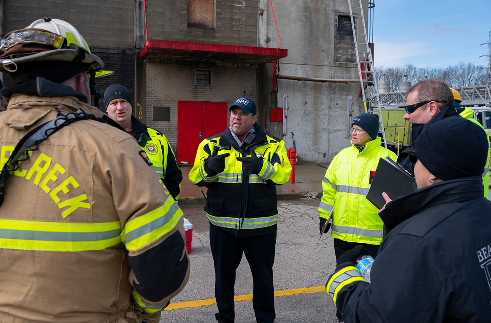 Mike Roberts (center) and Bryan Weeks (facing left) give feedback to Division Chief Scott Dorsten and the rest of the Beavercreek Township Fire Department on March 3, following a training exercise at the Dayton Fire Center. The two Wright-Patterson Air Force Base Fire Department assistant chiefs were asked to observe the exercise and evaluate the Beavercreek command structure. U.S. AIR FORCE PHOTO/R.J. ORIEZ