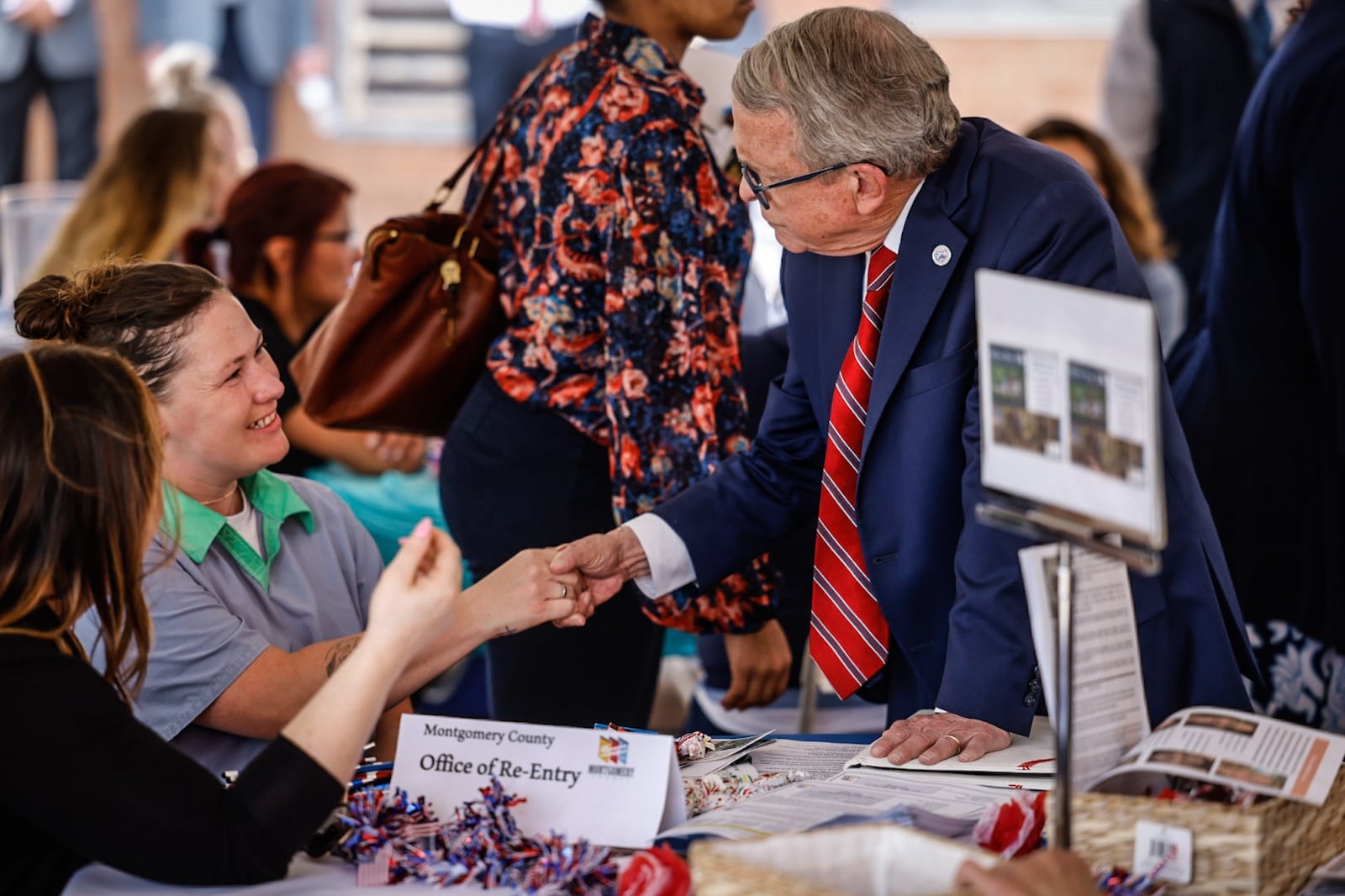 Ohio Gov. Mike DeWine greets Dayton Correctional Institution inmate, Mikka Winters, from Fayette County, before announcing a new initiative to train inmates to build the infrastructure necessary for broadband expansion throughout the state. The event was held at Dayton Correctional Institution Tuesday morning May 23, 2023. JIM NOELKER/STAFF