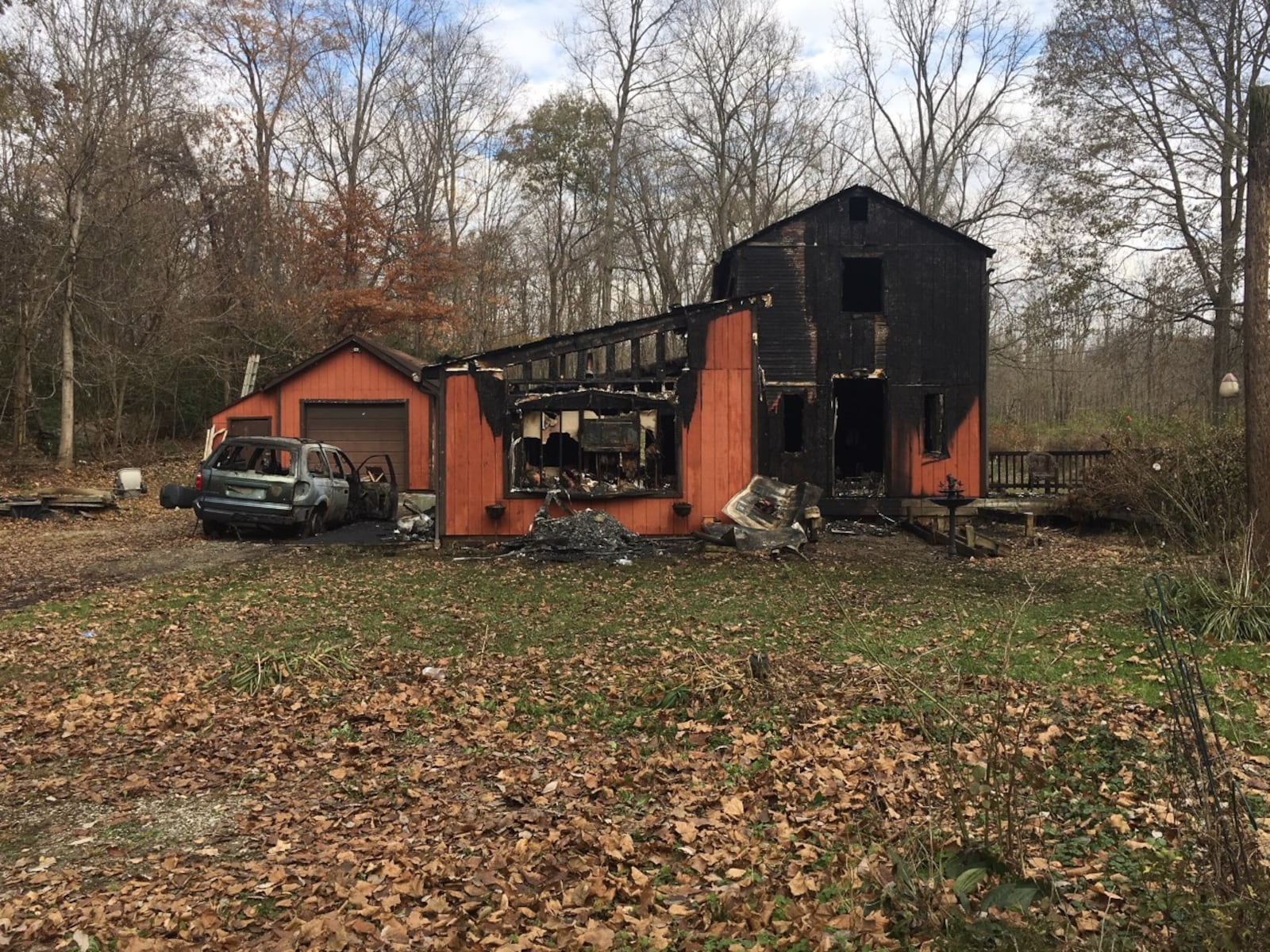 The charred remains of a home can be seen in the 500 block of Little York Road in Butler Twp. Sunday morning. Jeffrey Brown/Staff