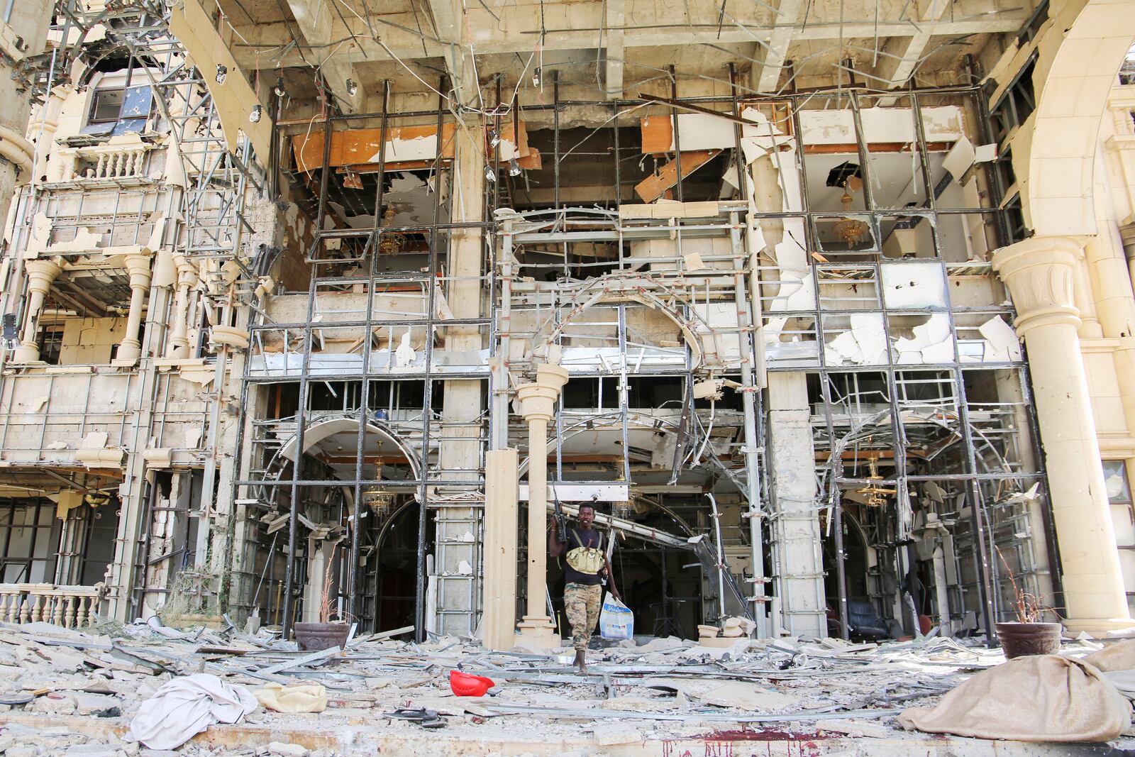 An army soldier walks in front of the damaged Republican Palace in Khartoum, Sudan, after it was taken over by Sudan's army Friday, March 21, 2025. (AP Photo)