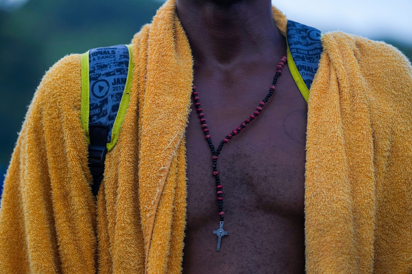 A rosary hangs from the neck of Cuban migrant Vladimir, as he walks along the Huixtla highway, in southern Mexico, Wednesday, Nov. 6, 2024, hoping to reach the country's northern border and ultimately the United States. (AP Photo/Moises Castillo)