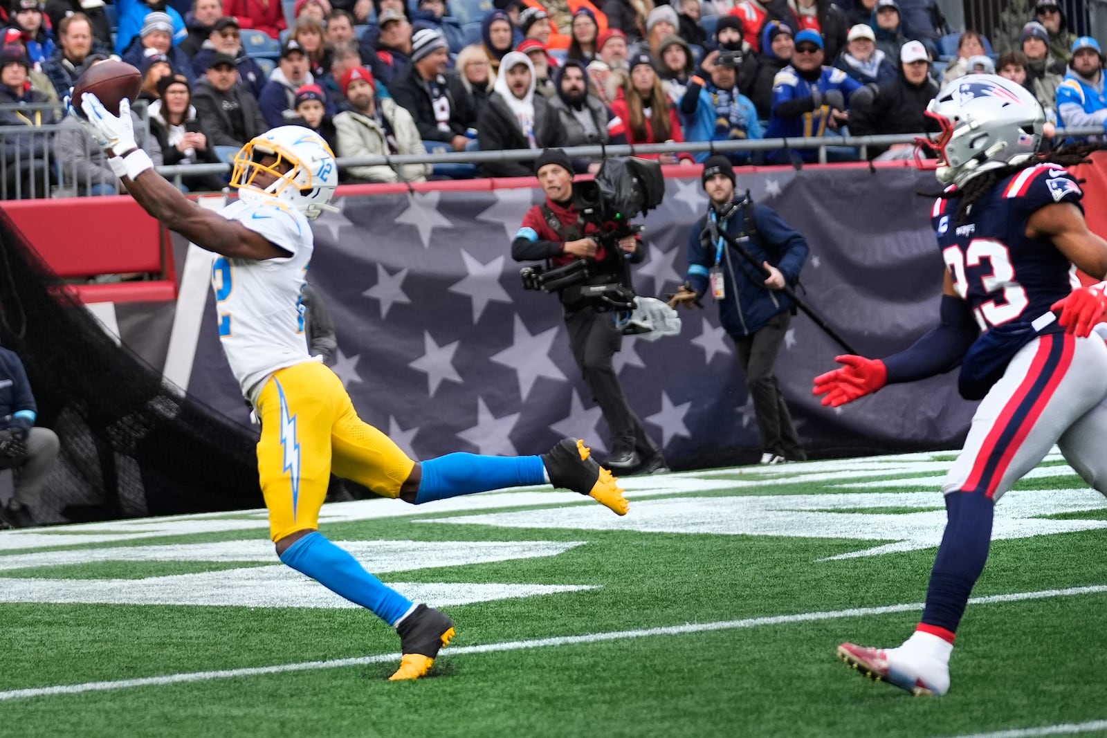 Los Angeles Chargers wide receiver Derius Davis (12) catches a touchdown pass against New England Patriots safety Kyle Dugger (23) during the first half of an NFL football game, Saturday, Dec. 28, 2024, in Foxborough, Mass. (AP Photo/Robert F. Bukaty)