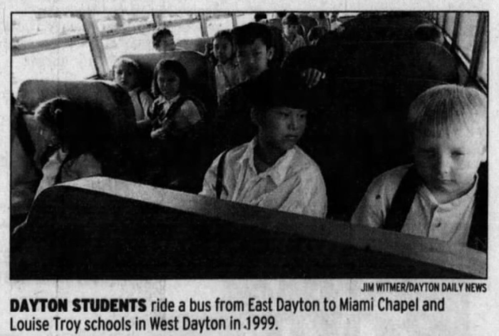 Elementary school students ride a bus to Louise Troy Elementary in West Dayton in 1999. Dayton Daily News Archives.