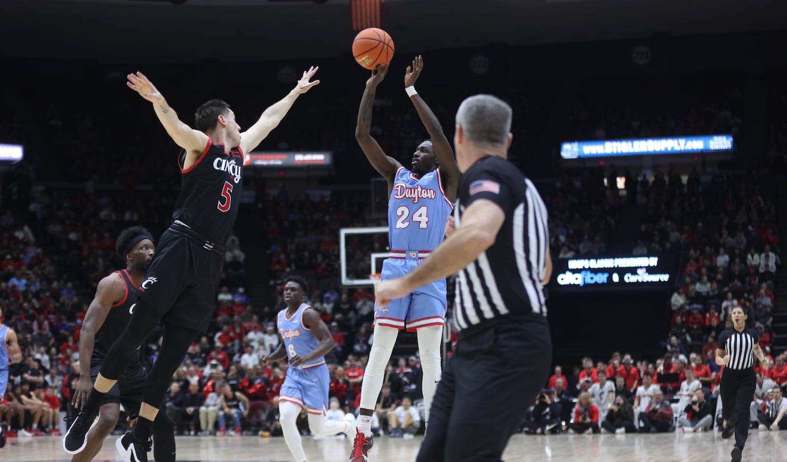 Dayton's Kobe Elvis makes a 3-pointer against Cincinnati on Saturday, Dec. 16, 2023, at the Heritage Bank Center in Cincinnati. David Jablonski/Staff