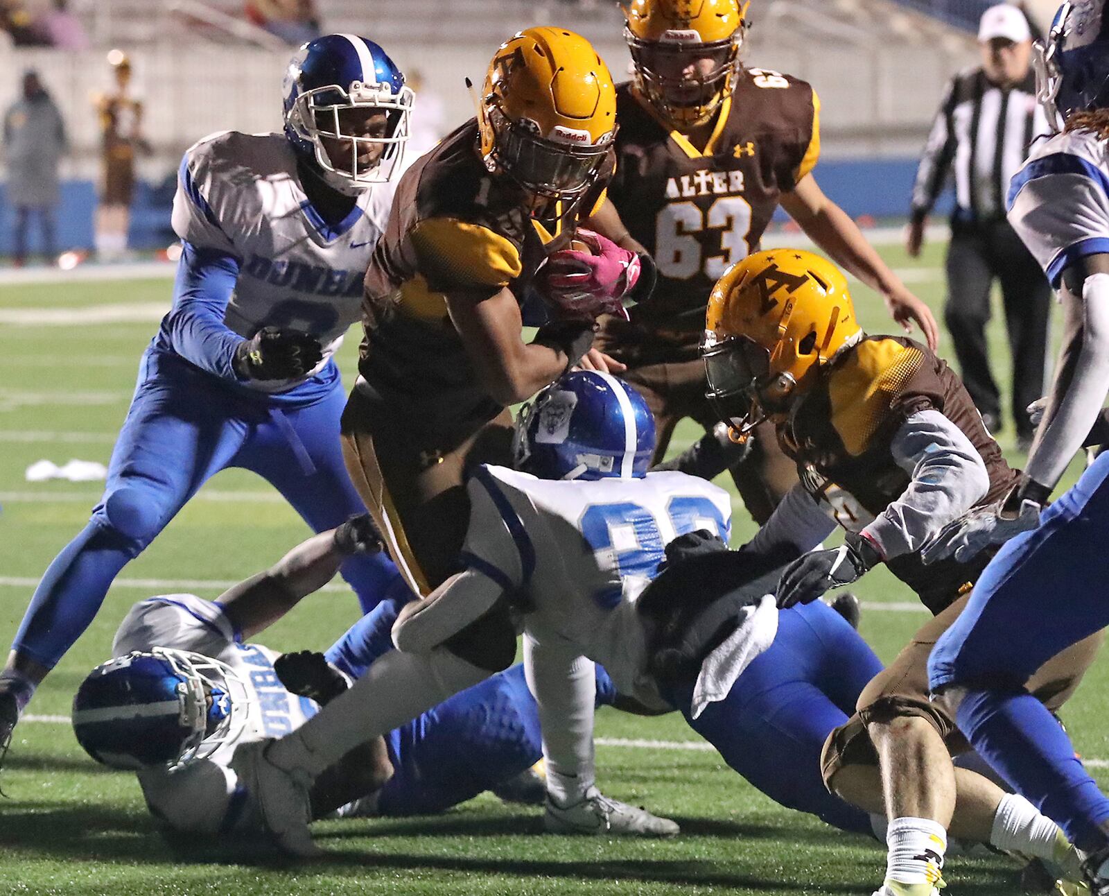 Alter's CJ Hicks drives up the middle against Dunbar Friday. BILL LACKEY/STAFF