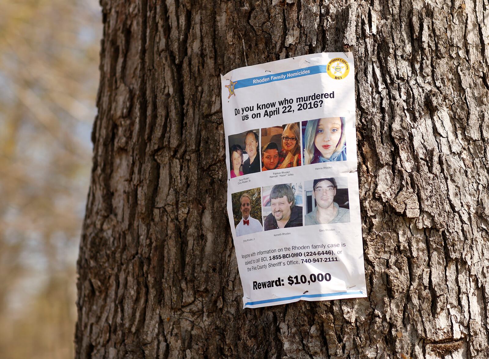 A reward poster for information about the Rhoden murders hangs on a tree in Pike County. Eight members of the Rhoden family were killed in rural Pike County in the early morning hours of April 22, 2016. The murder case remains unsolved. TY GREENLEES / STAFF