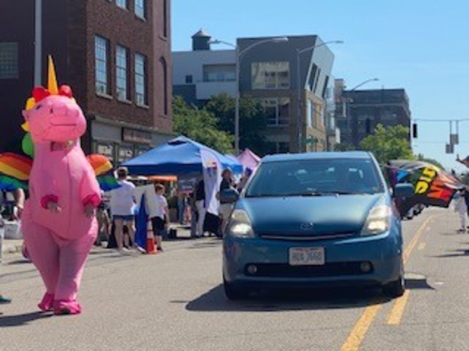 Pride celebrations were well underway at the Greater Dayton LGBT Center reverse parade on Saturday on East Second Street. Cars were decked out in bright colors, adorned with rainbow flags and hearts. In the air there were bubbles, car horns and chants of "love is love." Community allies passed out candy, snacks, and informational brochures to participants. The parade was followed by an LGBTQ+ Pride Festival at Courthouse Square.