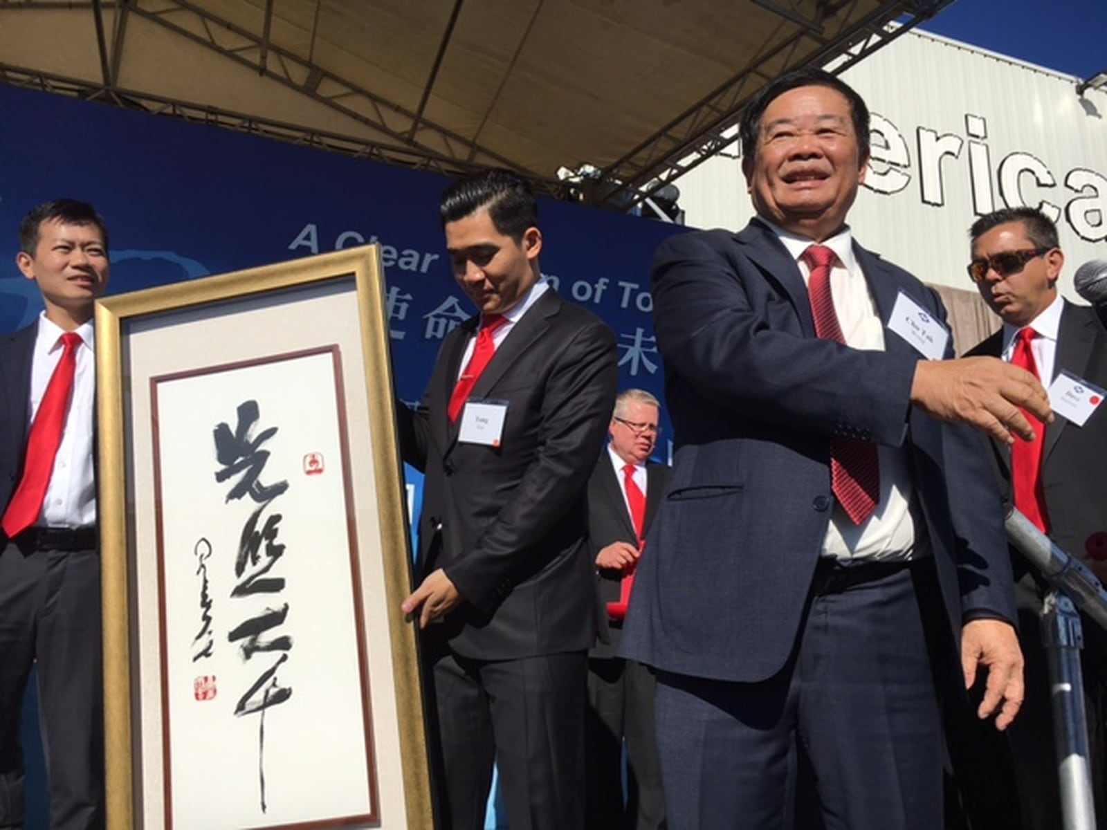 Cho Tak Wong, chairman of Fuyao Global -- seen here to the right of a Chinese gift -- estimated Friday that the Fuyao Glass America plant in Moraine could have 3,000 employees at some point, but he attached no timeline to that prediction. The plant has 2,000 employees today. THOMAS GNAU/STAFF