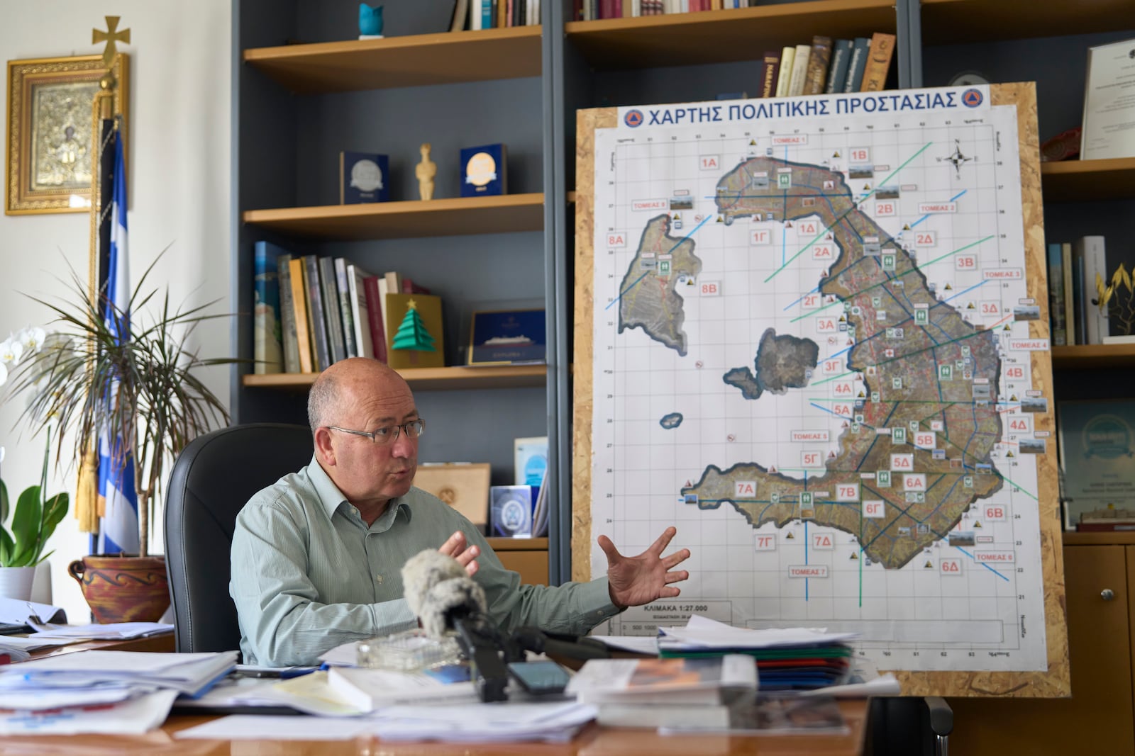 Santorini Mayor Nikos Zorzos speaks with the Associated Press moments before an earthquake that occurred during the interviewing in the Aegean Sea island of Santorini, Greece, Tuesday, Feb. 4, 2025. (AP Photo/Petros Giannakouris)