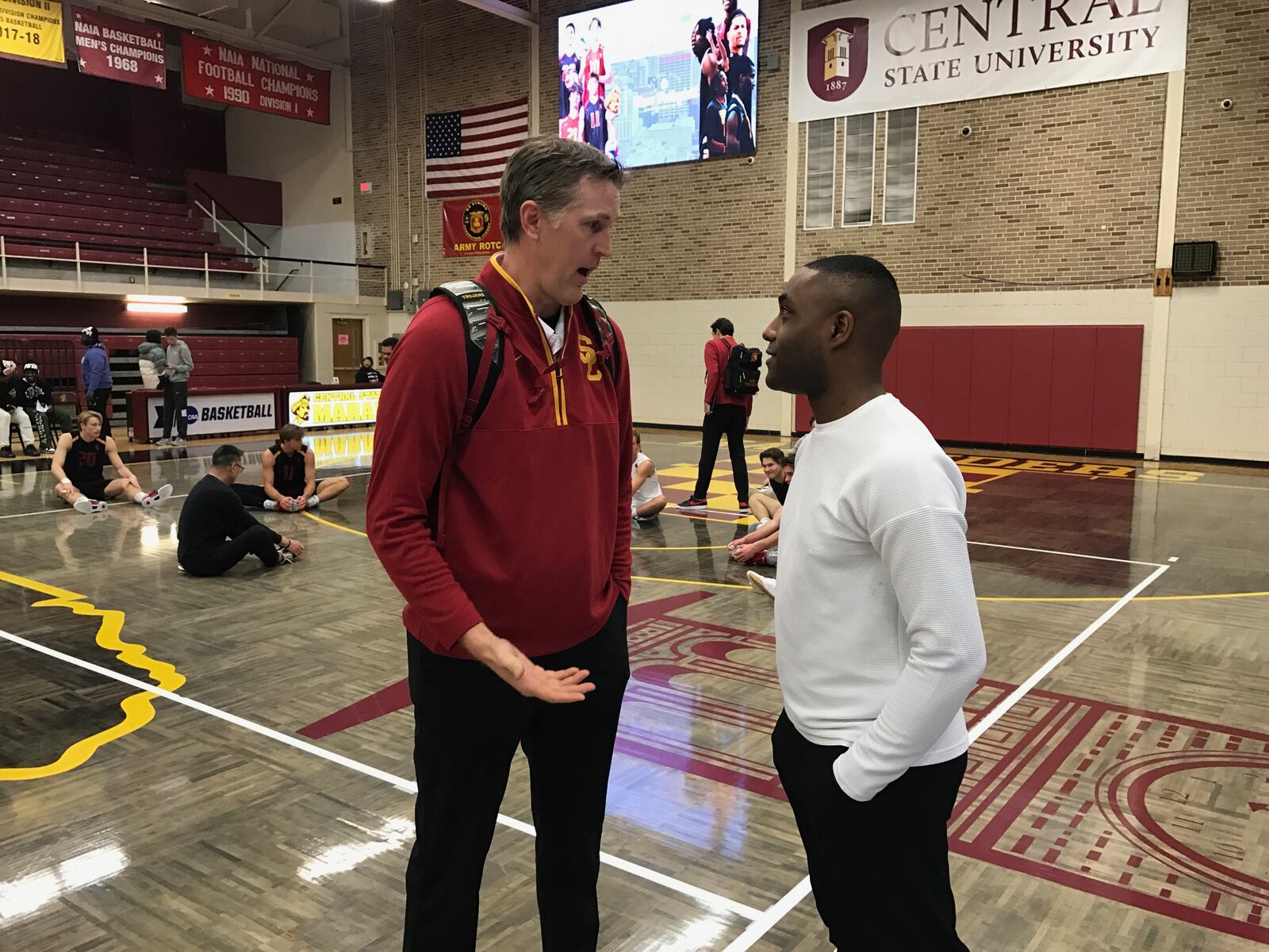 USC coach Jeff Nygard (left) talks to Central State coach Devin Walker after Wednesday night's match at CSU. Tom Archdeacon/CONTRIBUTED