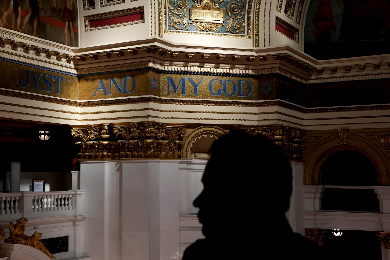 The silhouette of a visitor to the Pennsylvania Capitol in Harrisburg, Pa., on Sunday, Oct. 27, 2024. (AP Photo/Luis Andres Henao)