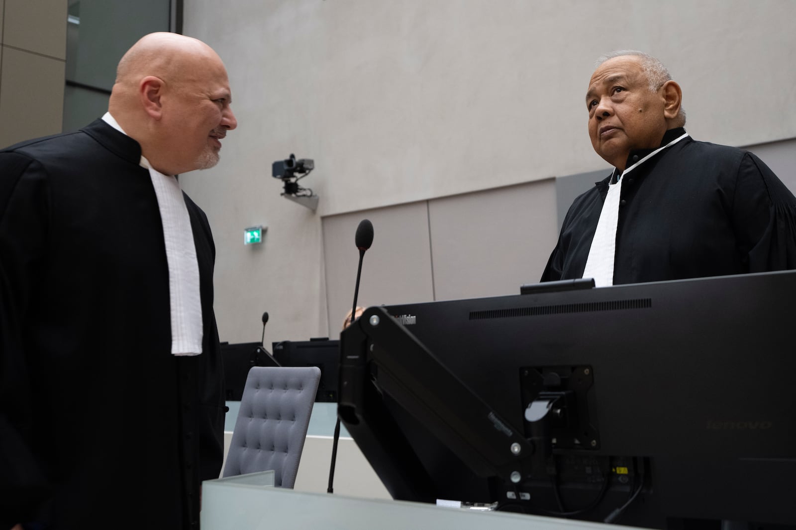 Duterte's lawyer Salvador Medialdea, right, talks to Chief Prosecutor Karim Khan, left, before former Philippine President Rodrigo Duterte appeared via video link before the International Criminal Court (ICC) in The Hague, Netherlands, Friday, March 14, 2025. (AP Photo/Peter Dejong, Pool)