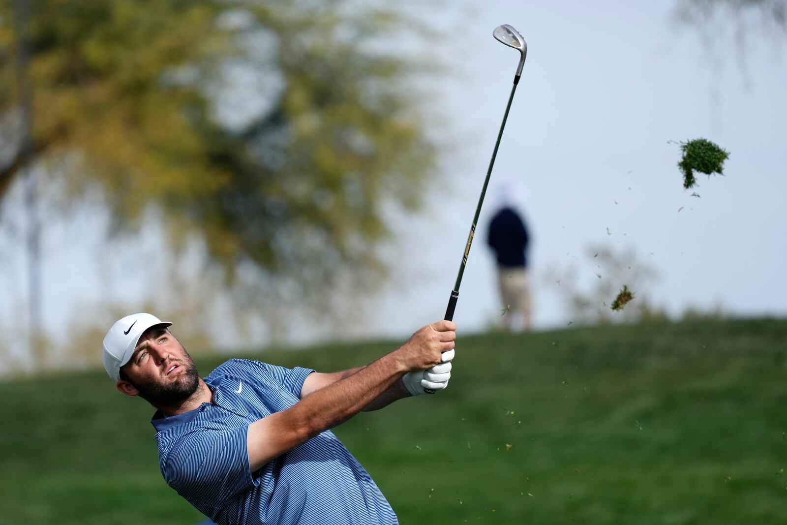 Scottie Scheffler hits his approach shot at the second hole during the final round of the Phoenix Open golf tournament at TPC Scottsdale Sunday, Feb. 9, 2025, in Scottsdale, Ariz. (AP Photo/Ross D. Franklin)