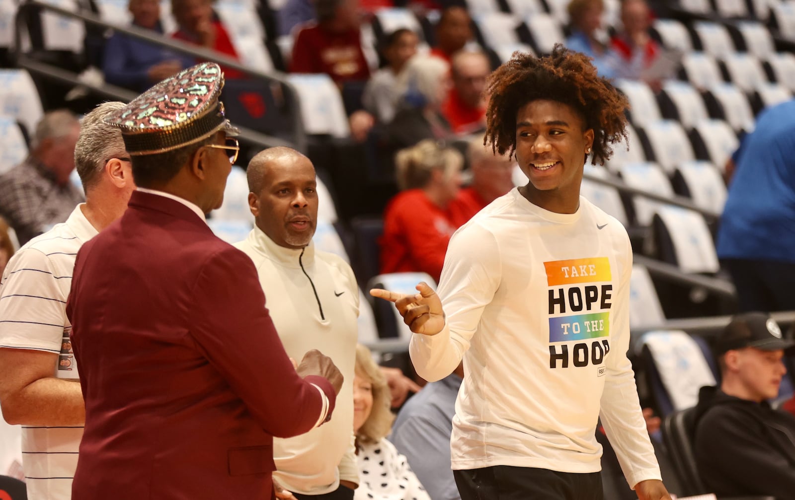 Dayton's Marvel Allen, right, talks to former Flyer J.D. Grigsby before an exhibition game against Xavier on Sunday, Oct. 20, 2024, at UD Arena. David Jablonski/Staff