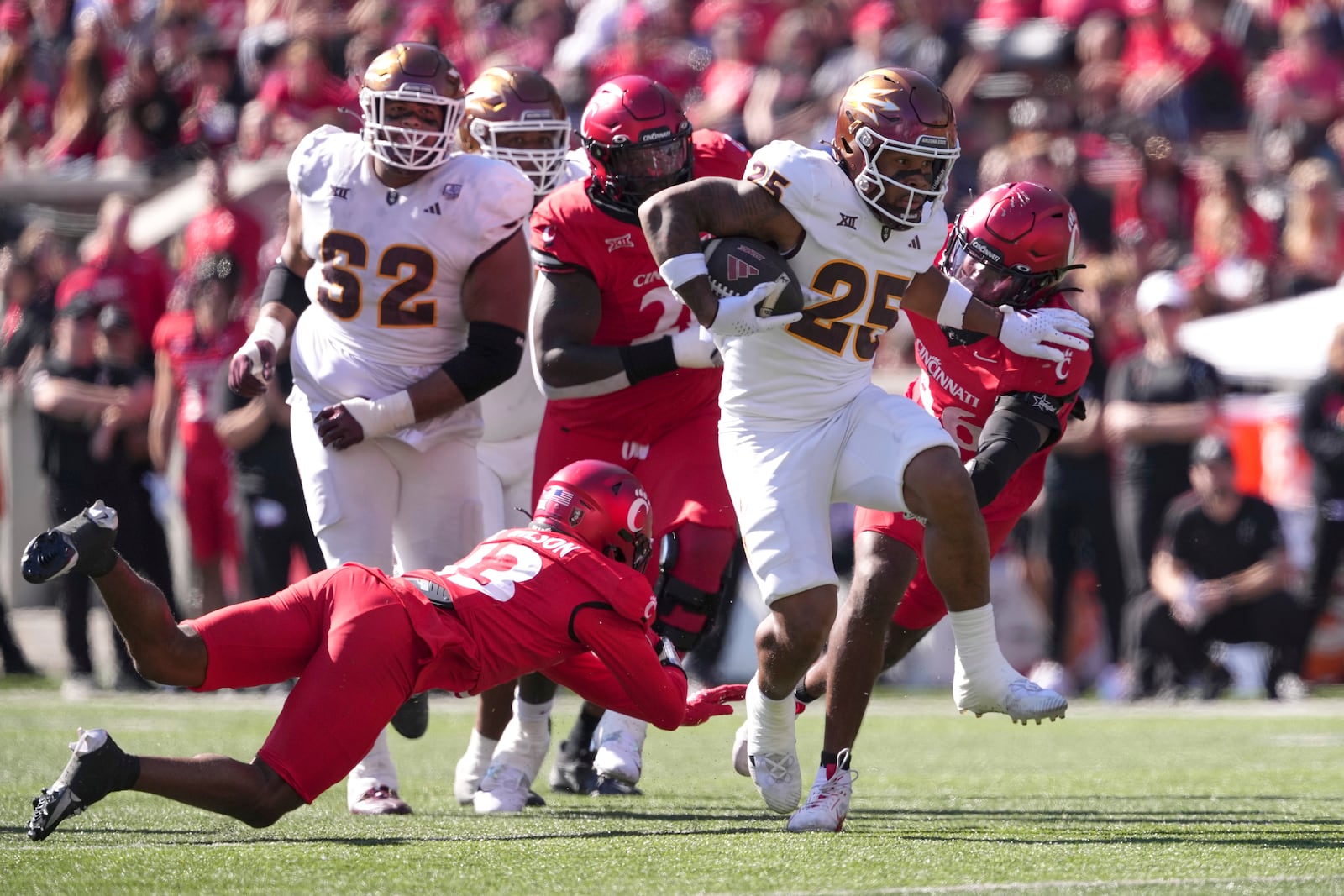 Arizona State's DeCarlos Brooks breaks a tackle by Cincinnati's Logan Wilson during the second half of an NCAA college football game, Saturday, Oct. 19, 2024, in Cincinnati. (AP Photo/Kareem Elgazzar)