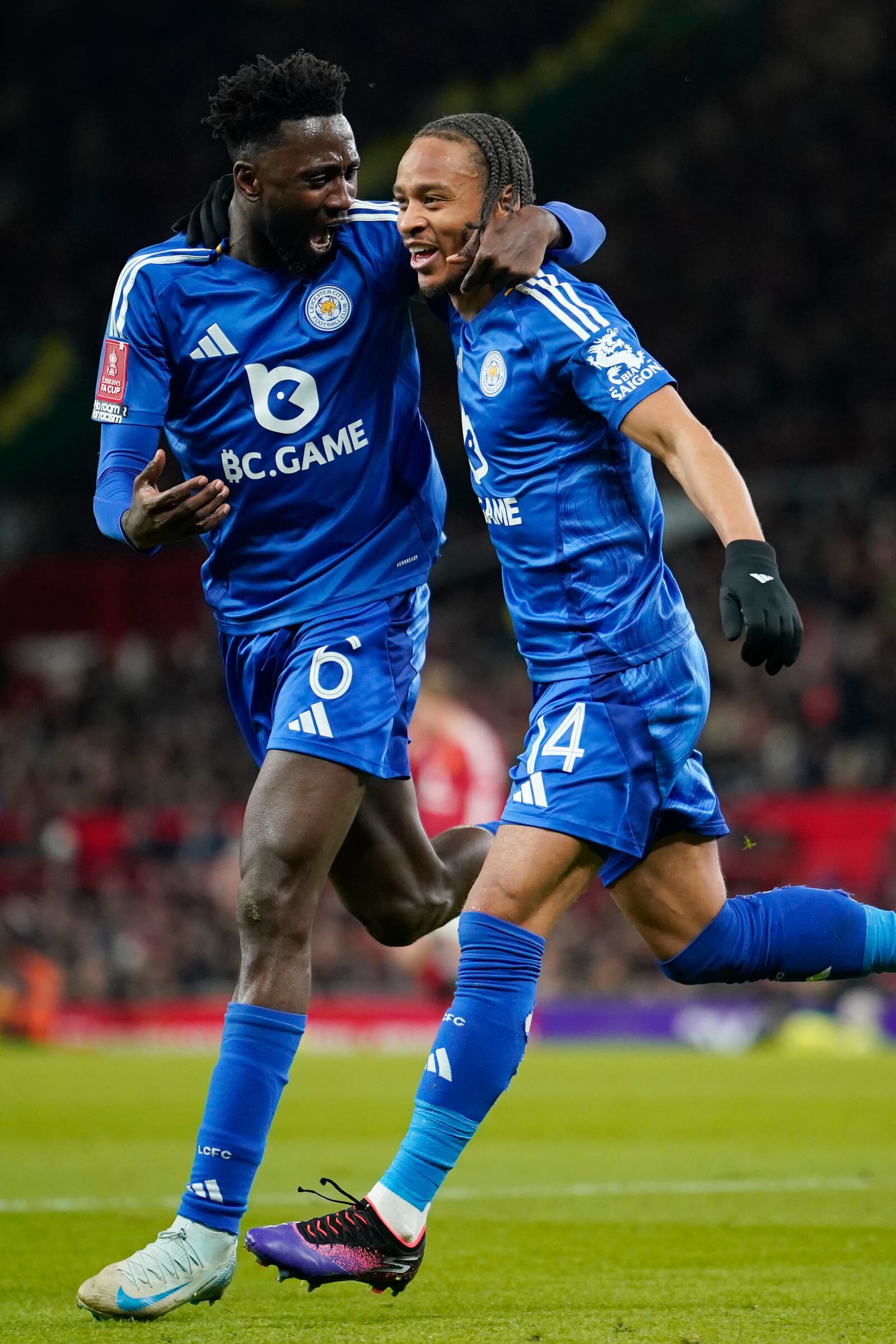 Leicester's Bobby Decordova-Reid, right, celebrates with Leicester's Wilfred Ndidi after scoring the opening goal during the English FA Cup fourth round soccer match between Manchester United and Leicester City at the Old Trafford stadium in Manchester, England, Friday, Feb. 7, 2025. (AP Photo/Dave Thompson)