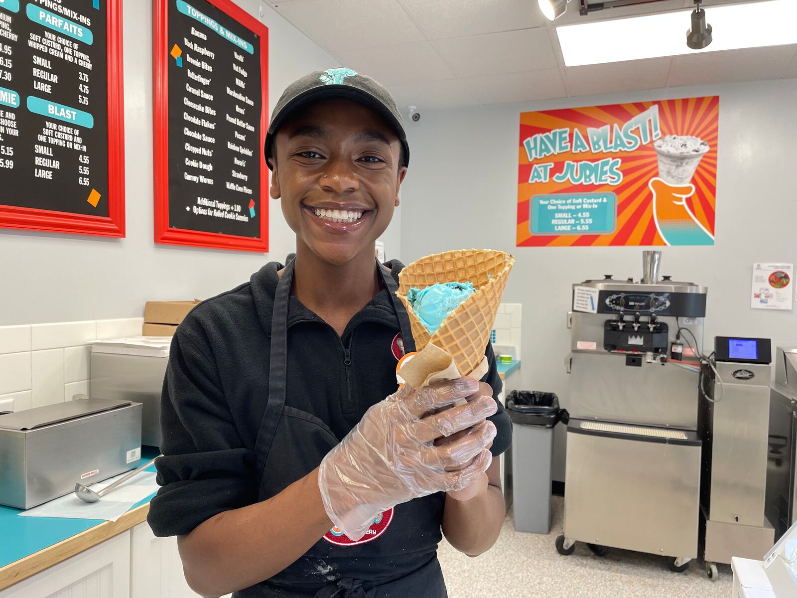 Christian Walker-Beasley, the team lead and social media intern at Jubie’s Creamery in Fairborn, holds a one scoop waffle cone.