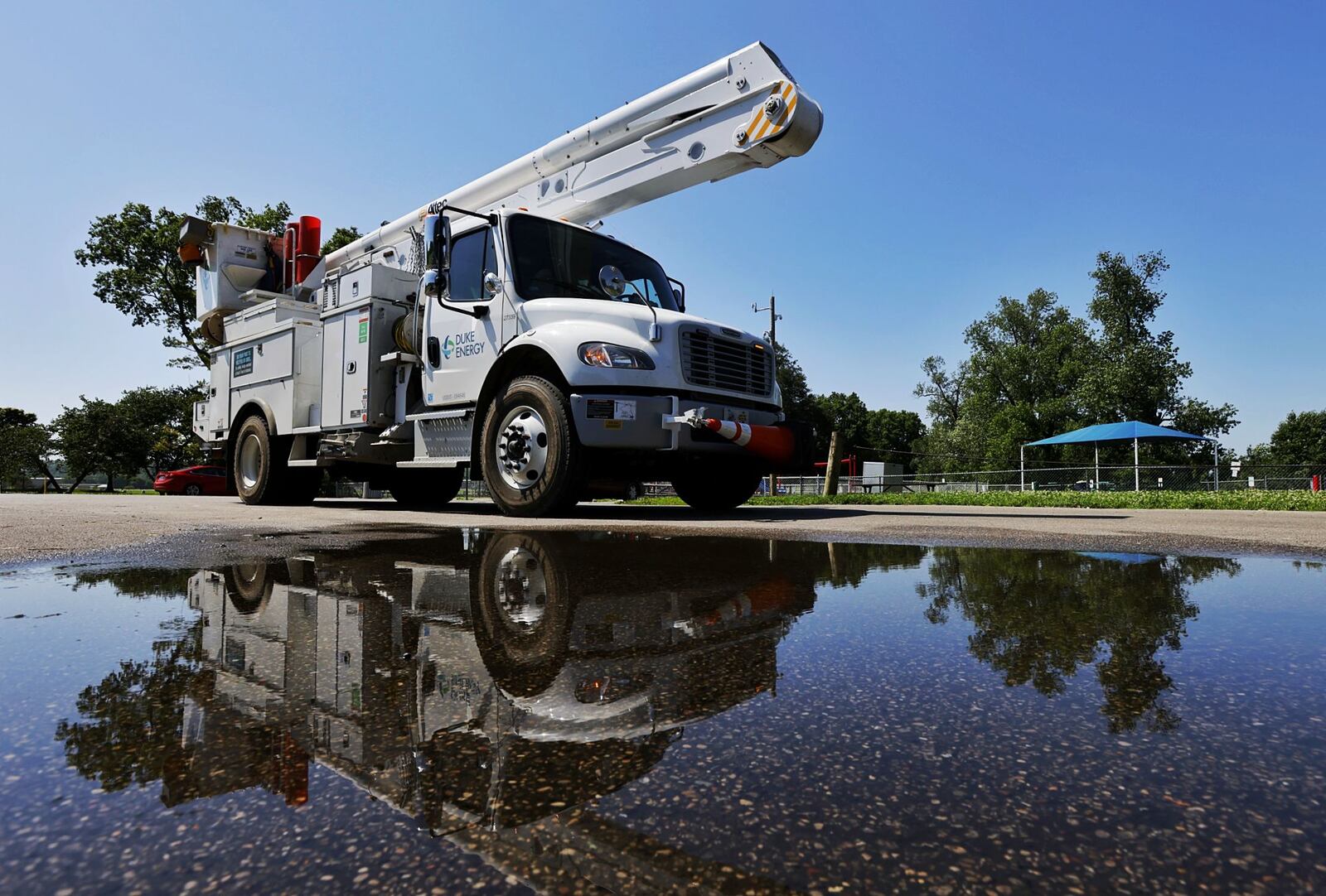 A Duke Energy crew responded to Smith Park to repair downed power lines. Many were without power in Middletown Tuesday, June 14, 2022 after a storm knocked down trees and limbs creating power outages. NICK GRAHAM/STAFF