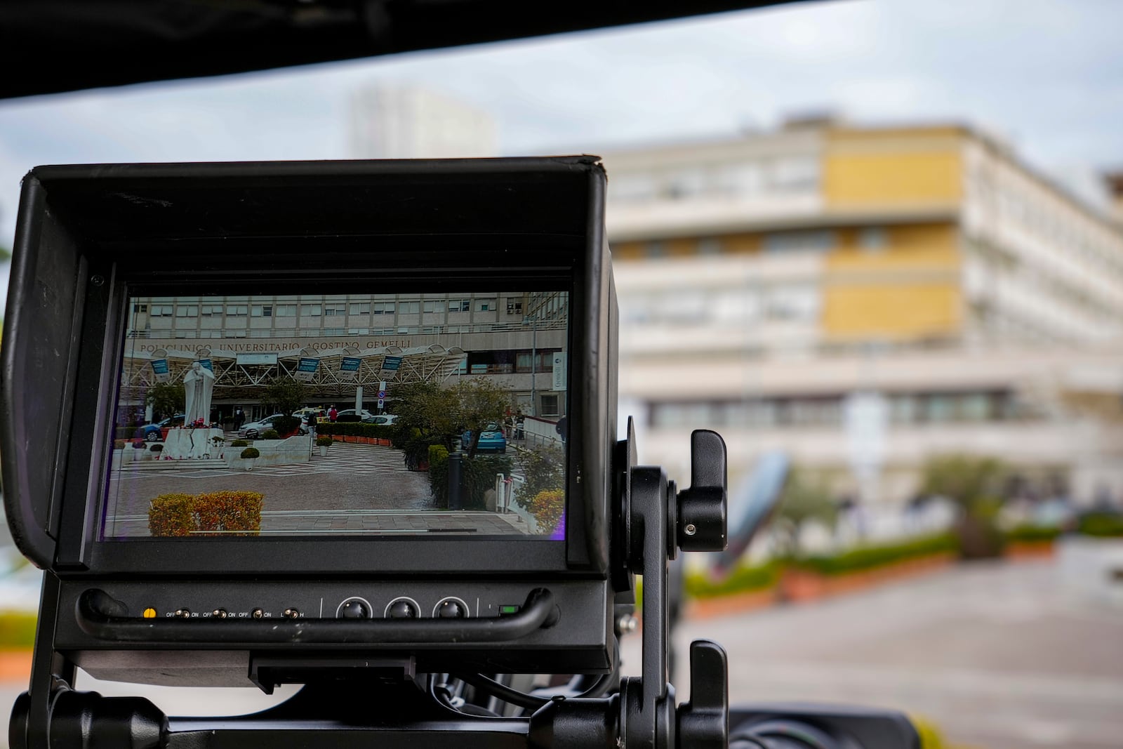 The main entrance of the Agostino Gemelli Polyclinic, where Pope Francis has been hospitalized, is seen on the screen of a video camera, in Rome, Monday, Feb. 17, 2025. (AP Photo/Andrew Medichini)