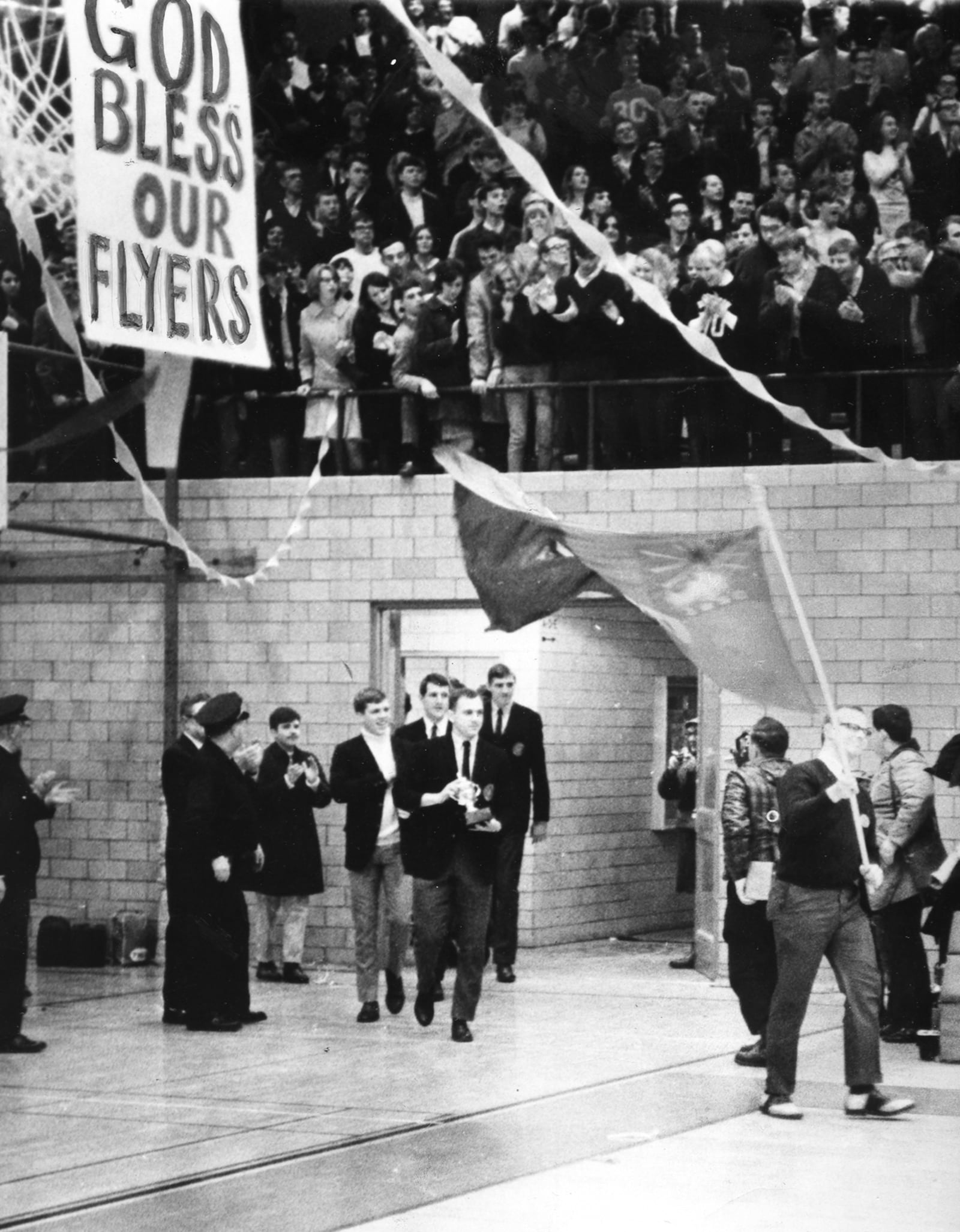 The University of Dayton Flyers men's basketball team won the 1968 National Invitational Tournament.  Flyer fans crowded the UD Fieldhouse to welcome the victorious team home.