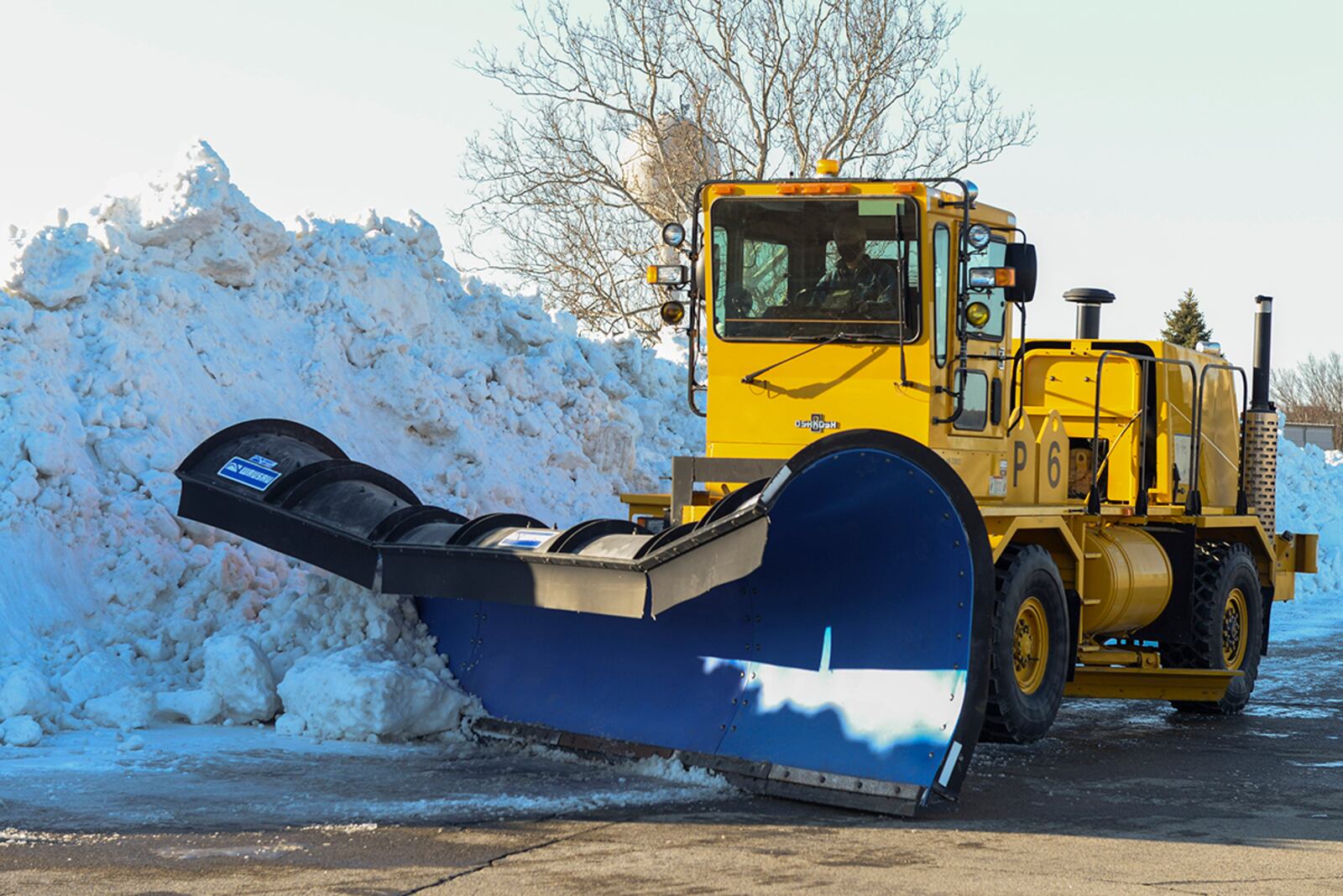 A plow operator with the 88th Civil Engineer Squadron pushes snow into a huge pile last February on the flightline at Wright-Patterson Air Force Base. The squadron’s Snow and Ice Control Plan outlines annual training and assigns personnel and equipment to areas and shifts for 24-hour operations should the clouds darken. U.S. AIR FORCE PHOTO/WESLEY FARNSWORTH